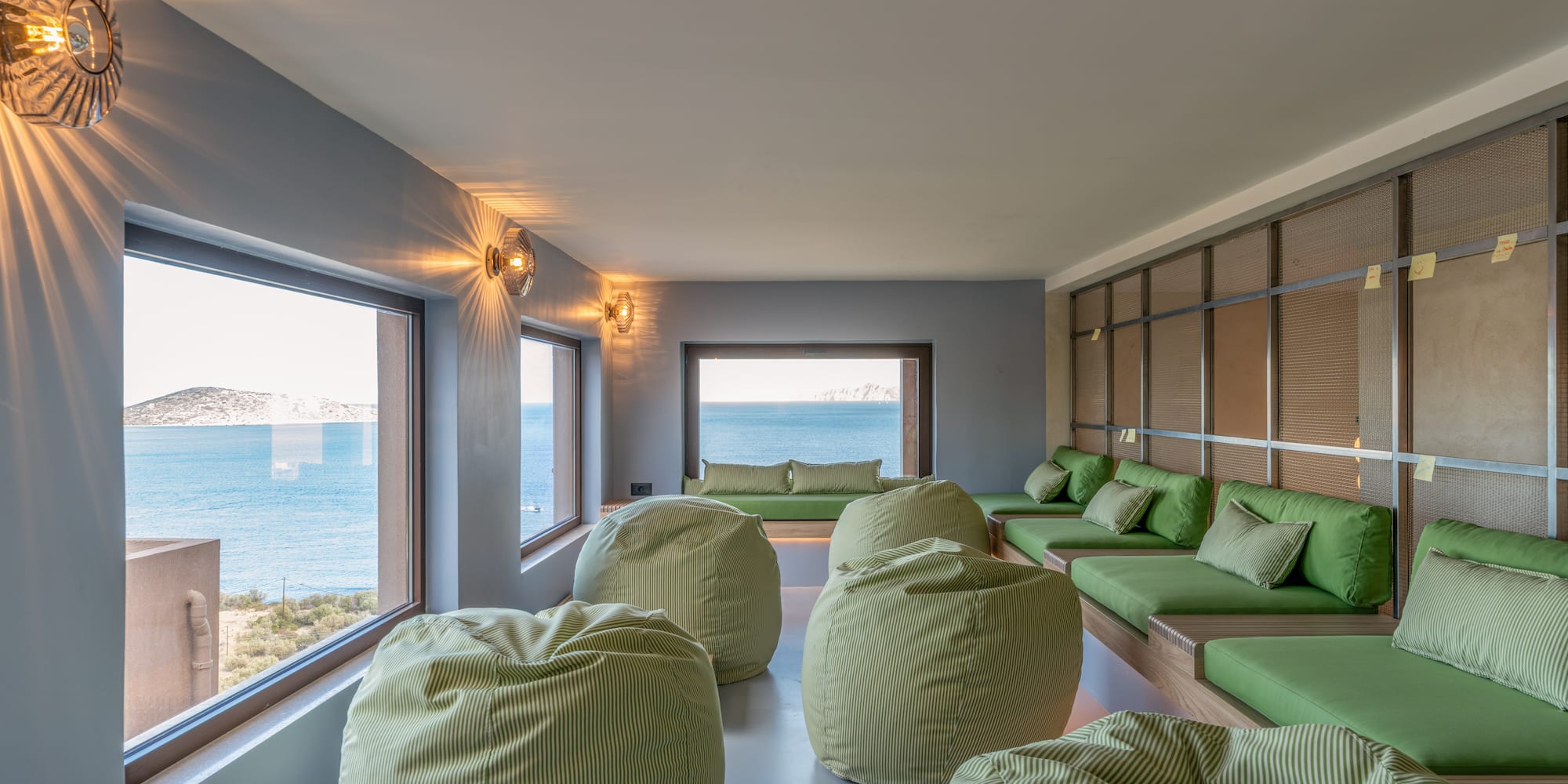 a room with green bean bags and a large window