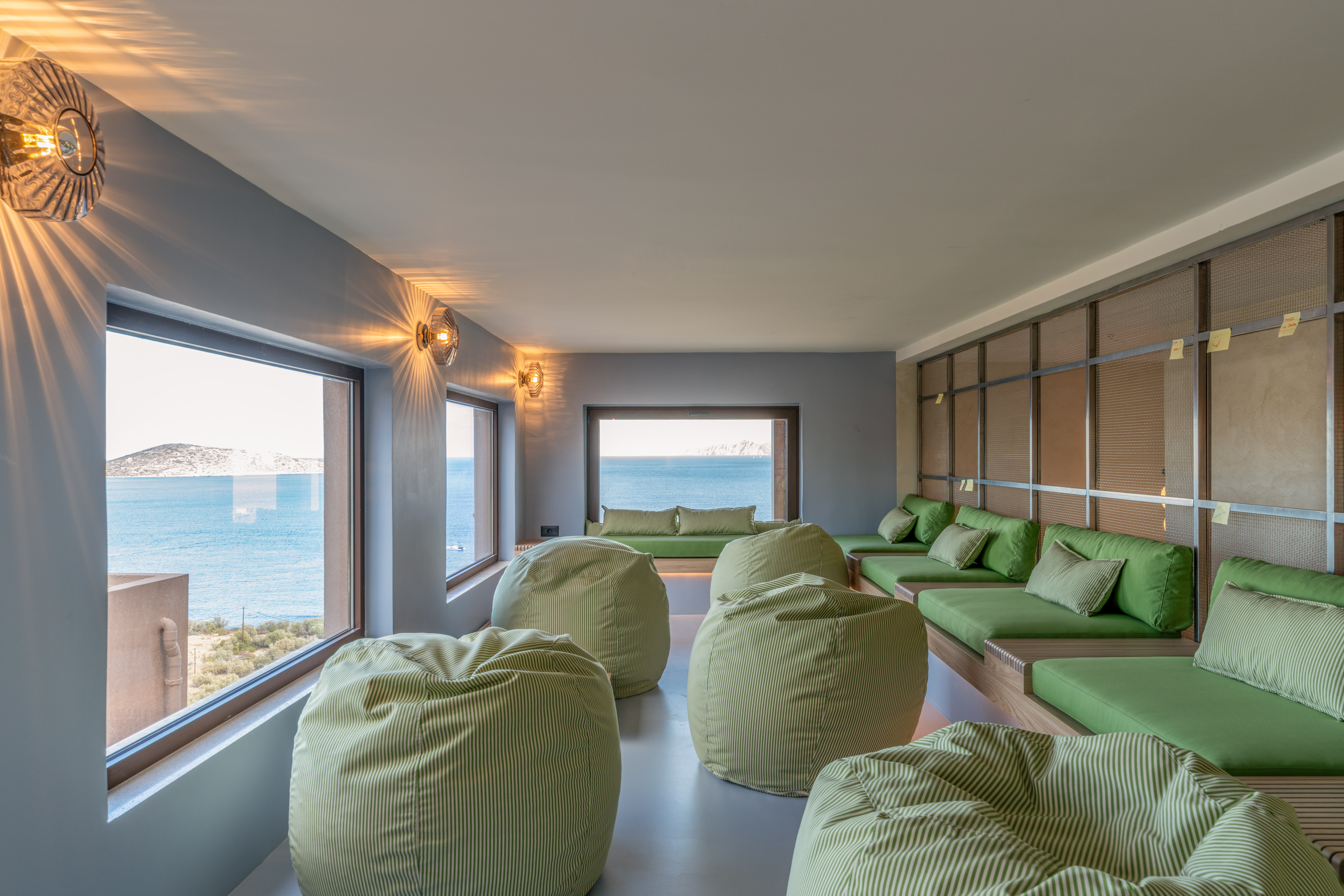 a room with green bean bags and a large window