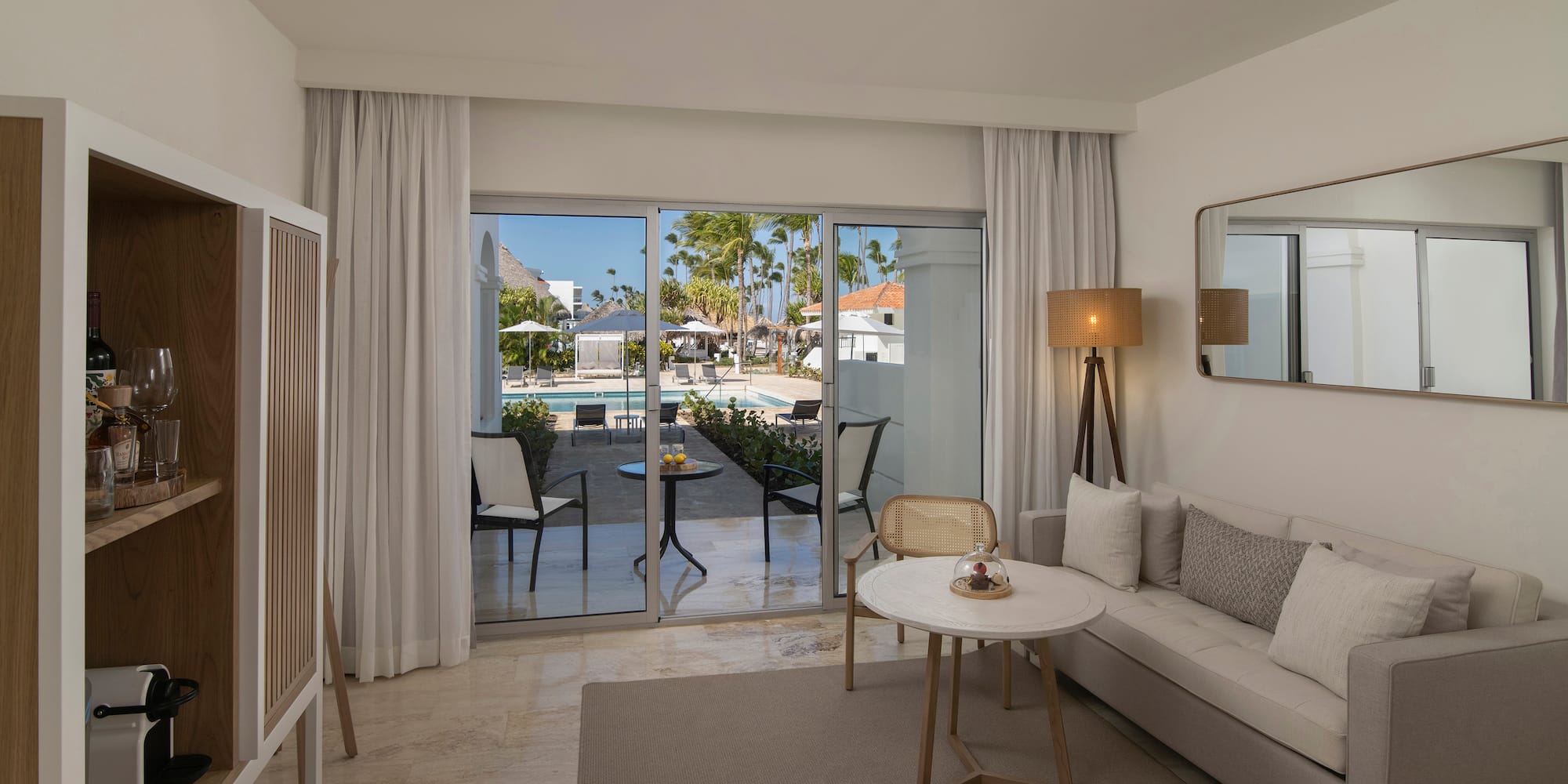 a room with a couch and a table and chairs