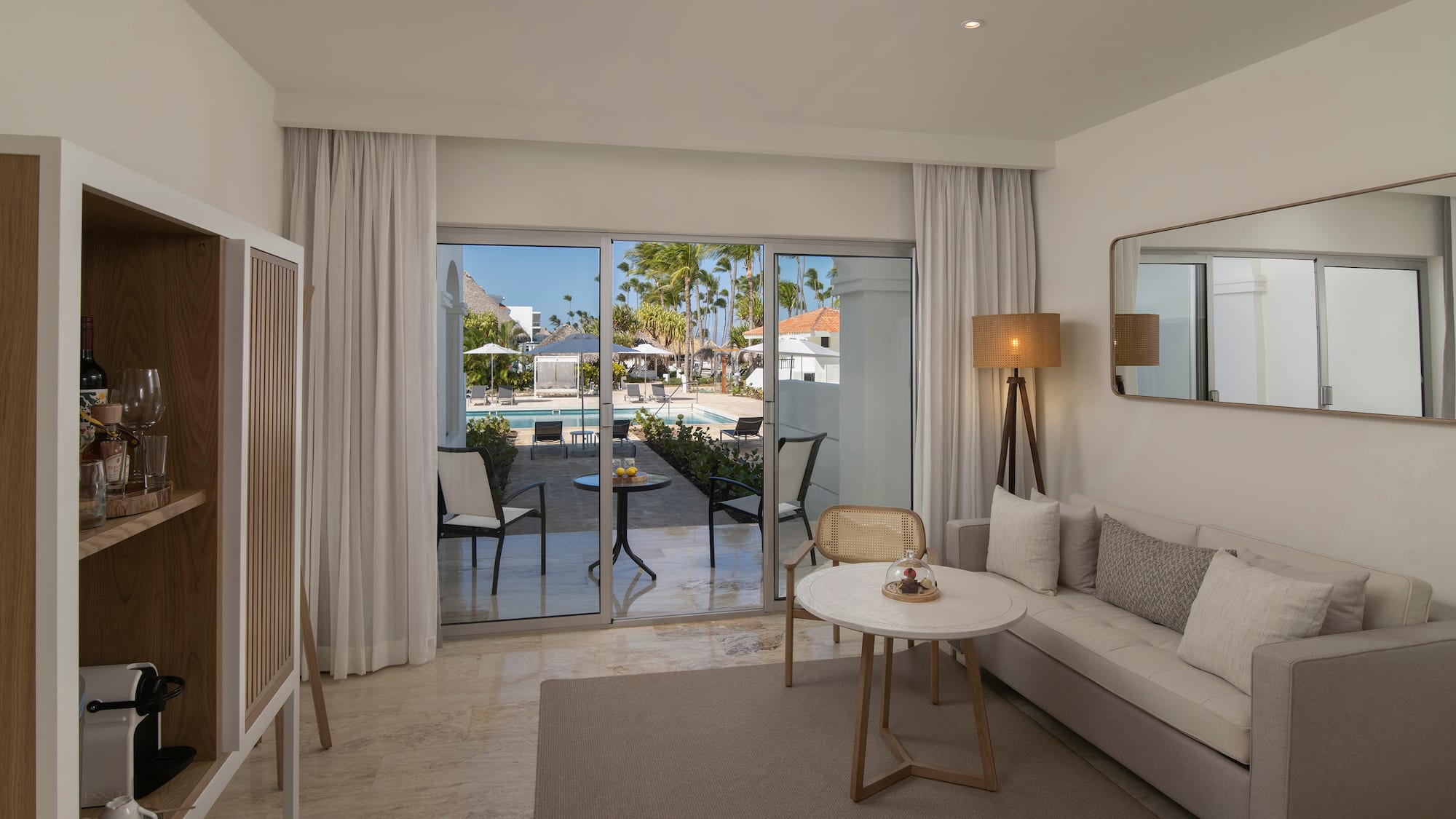 a room with a couch and a table and chairs