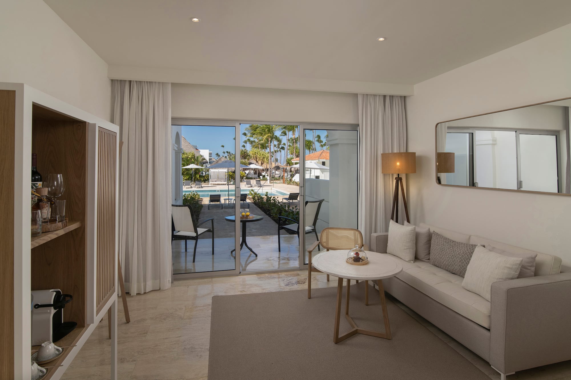 a room with a couch and a table and chairs