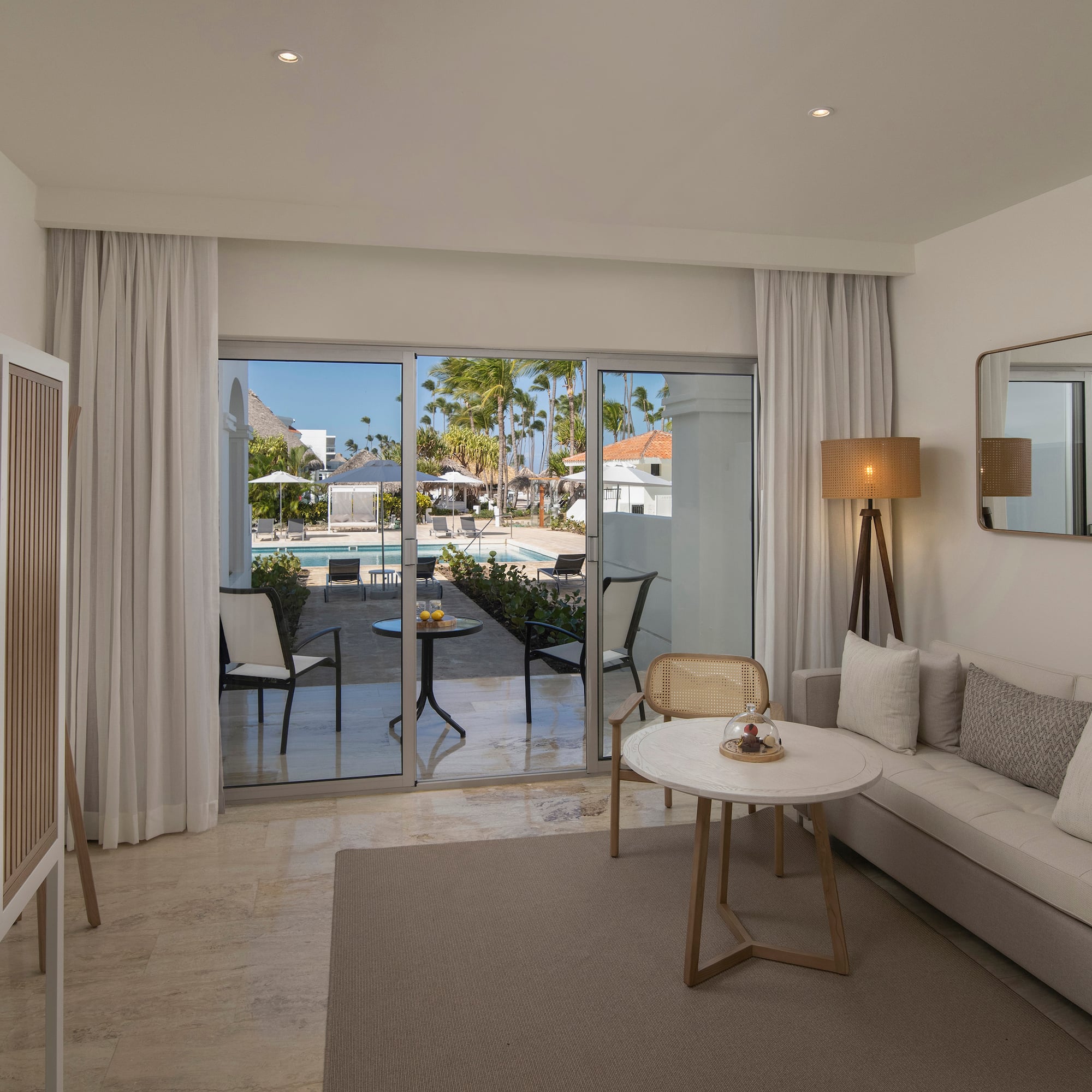 a room with a couch and a table and chairs