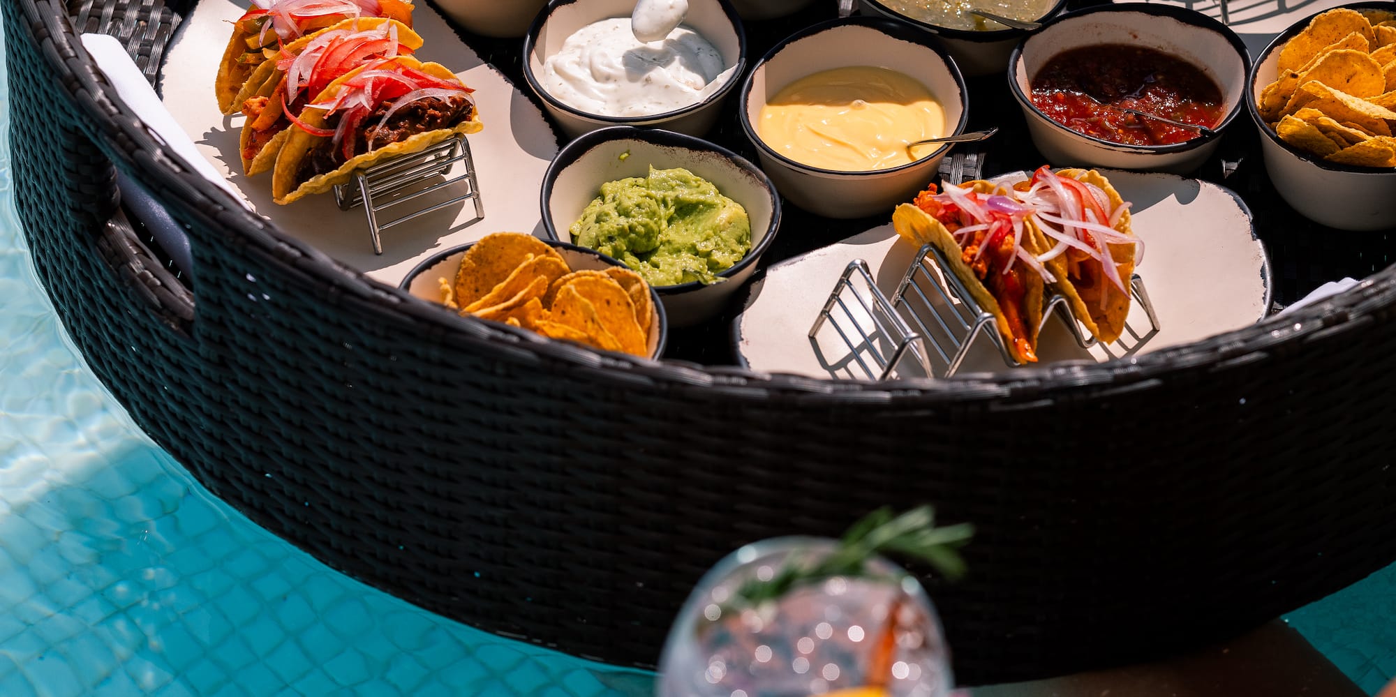 a person holding a drink and a bowl of food