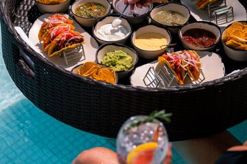 a person holding a drink and a bowl of food