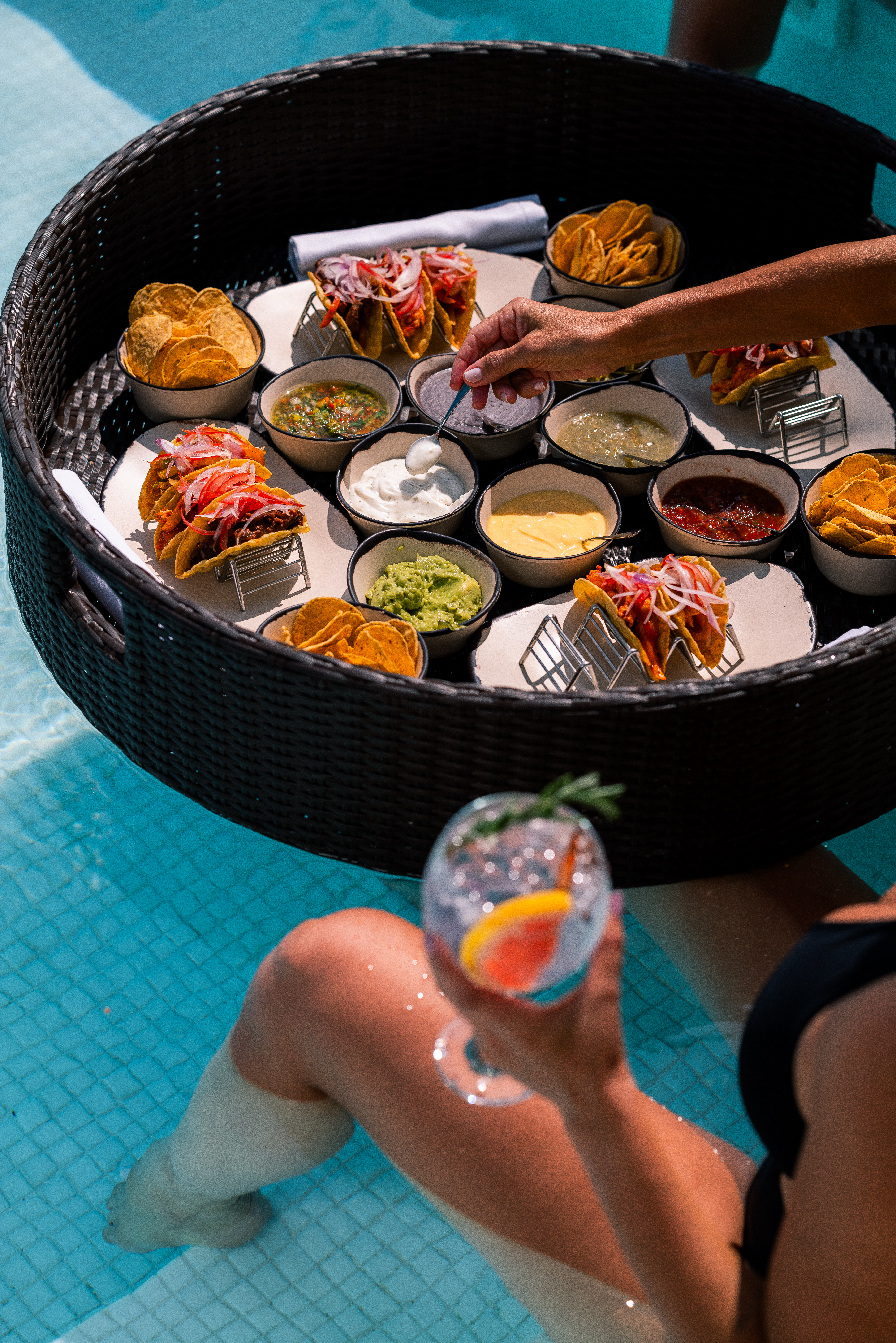 Floating pool tray: tacos, assorted dips, chips, and cocktail.