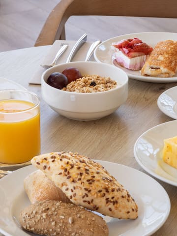 a table with plates of food and drinks
