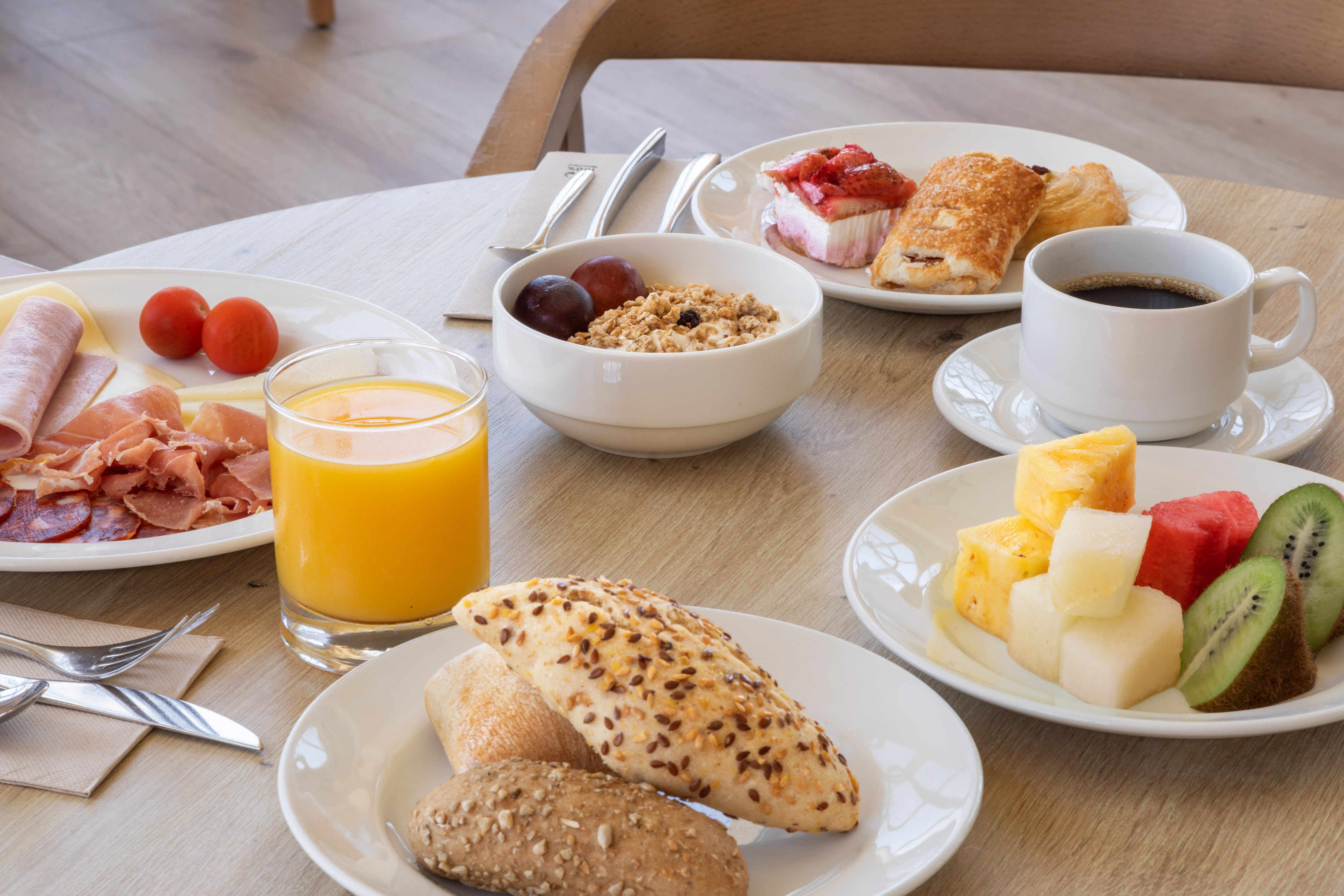 a table with plates of food and drinks