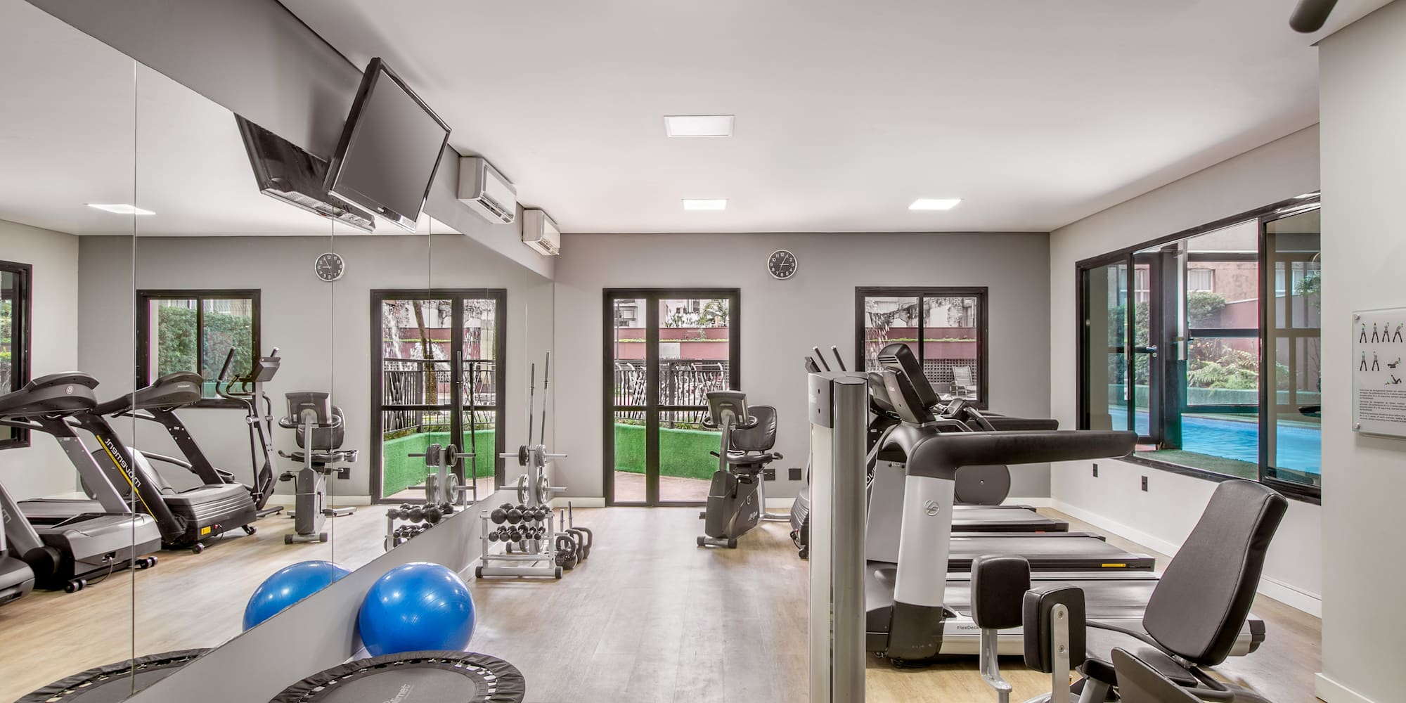 a room with exercise equipment and a television