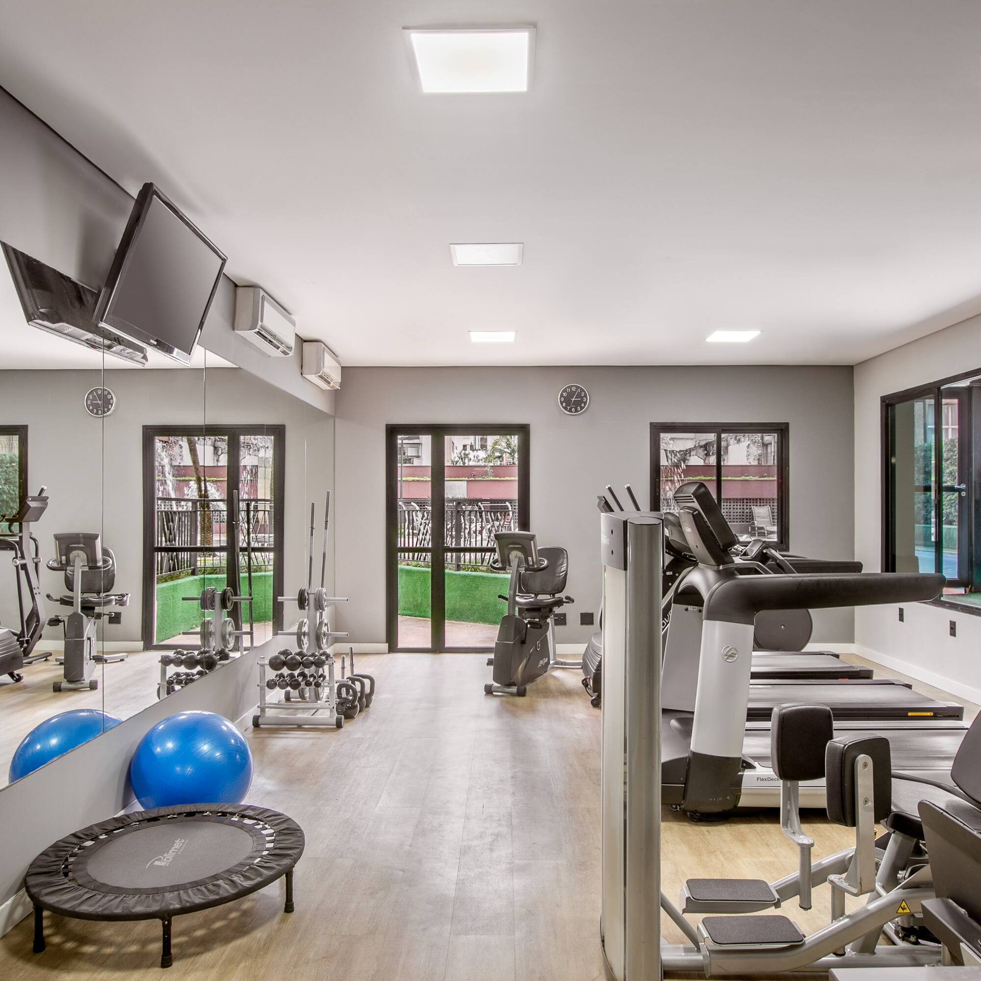 a room with exercise equipment and a television