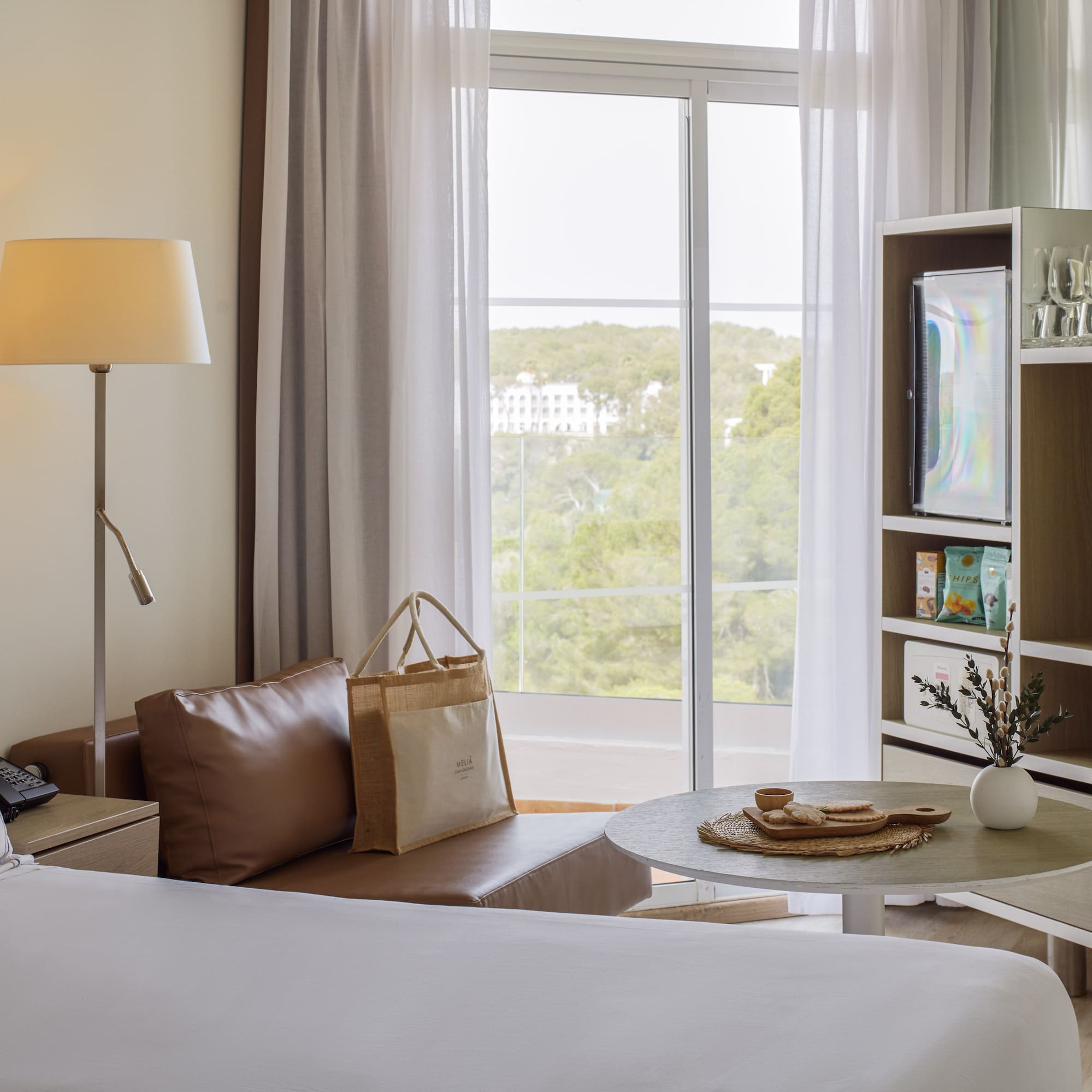 a room with a bed and a table and a television