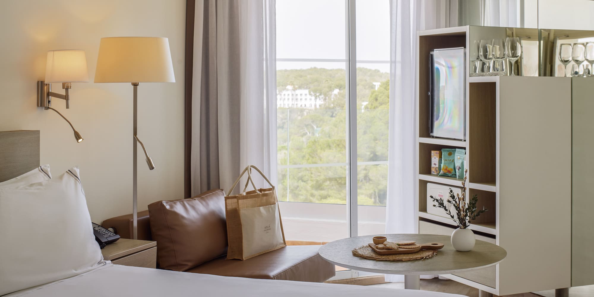 a room with a bed and a table and a television