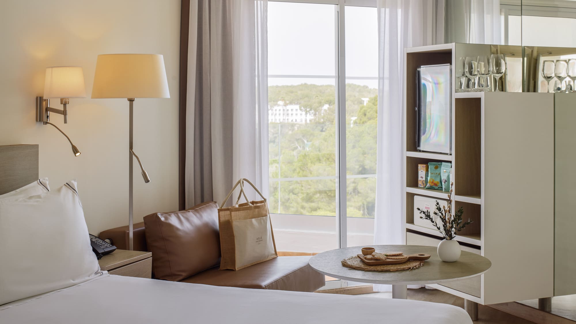 a room with a bed and a table and a television