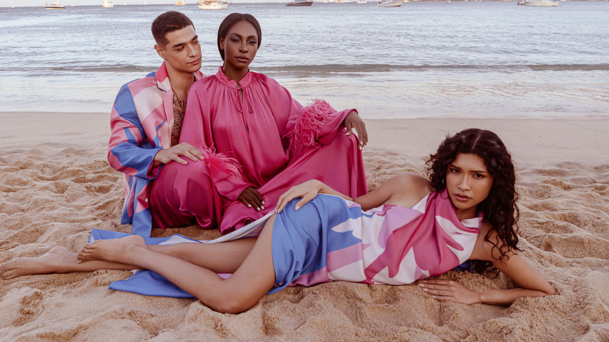 a group of people sitting on a beach