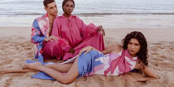 a group of people sitting on a beach