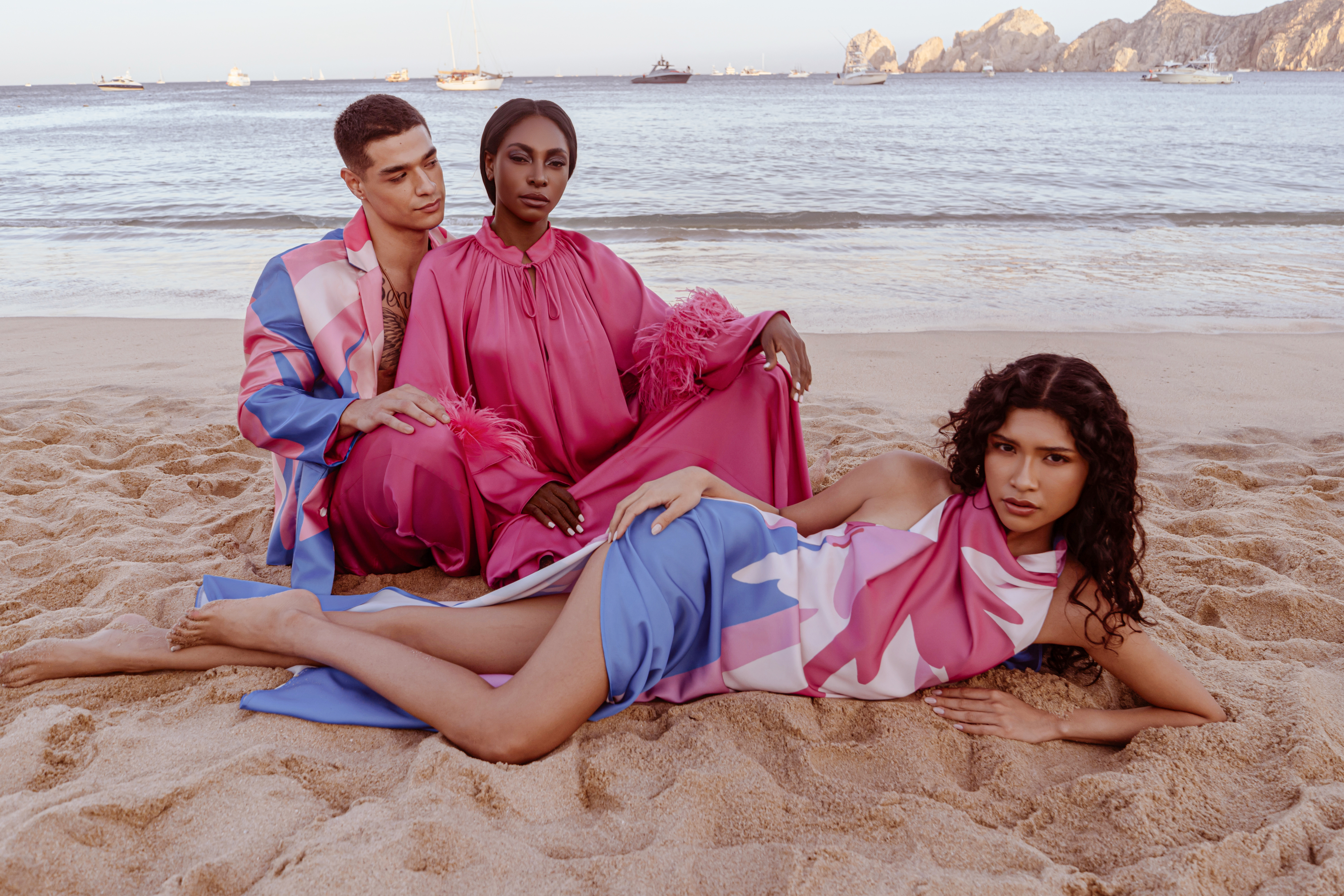 a group of people sitting on a beach