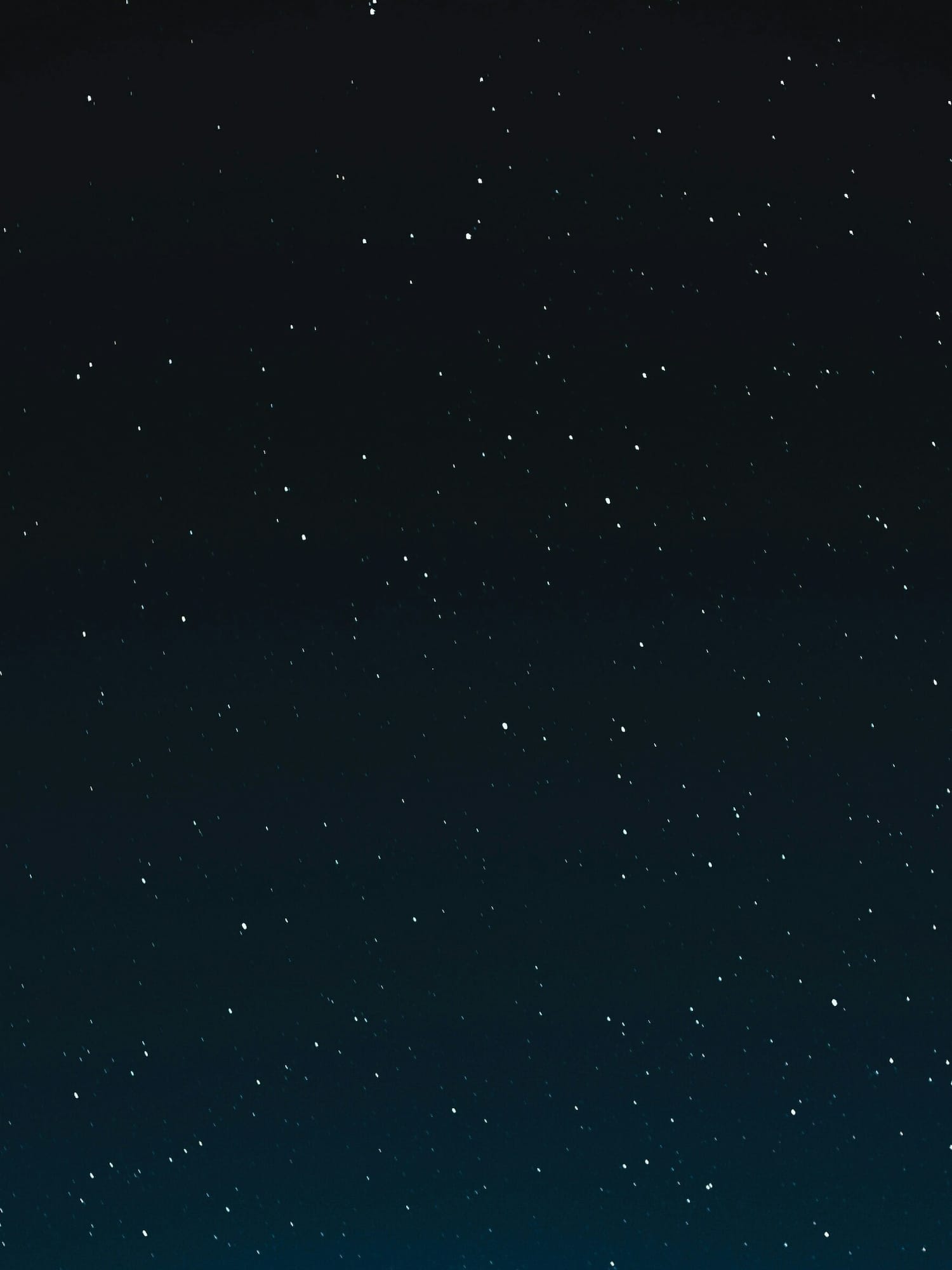 Starry night sky, dark blue with numerous white stars.