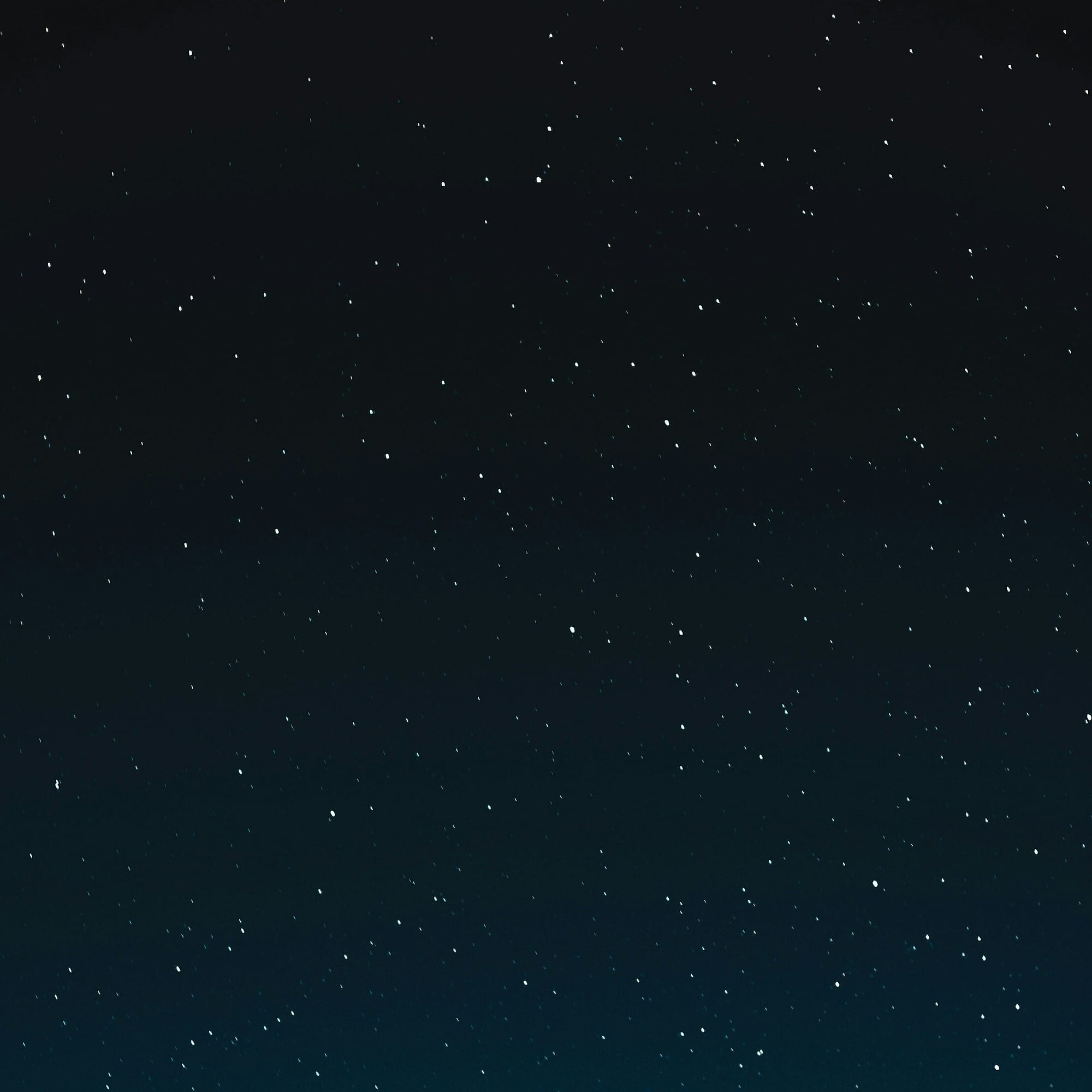 Starry night sky, dark blue with numerous white stars.
