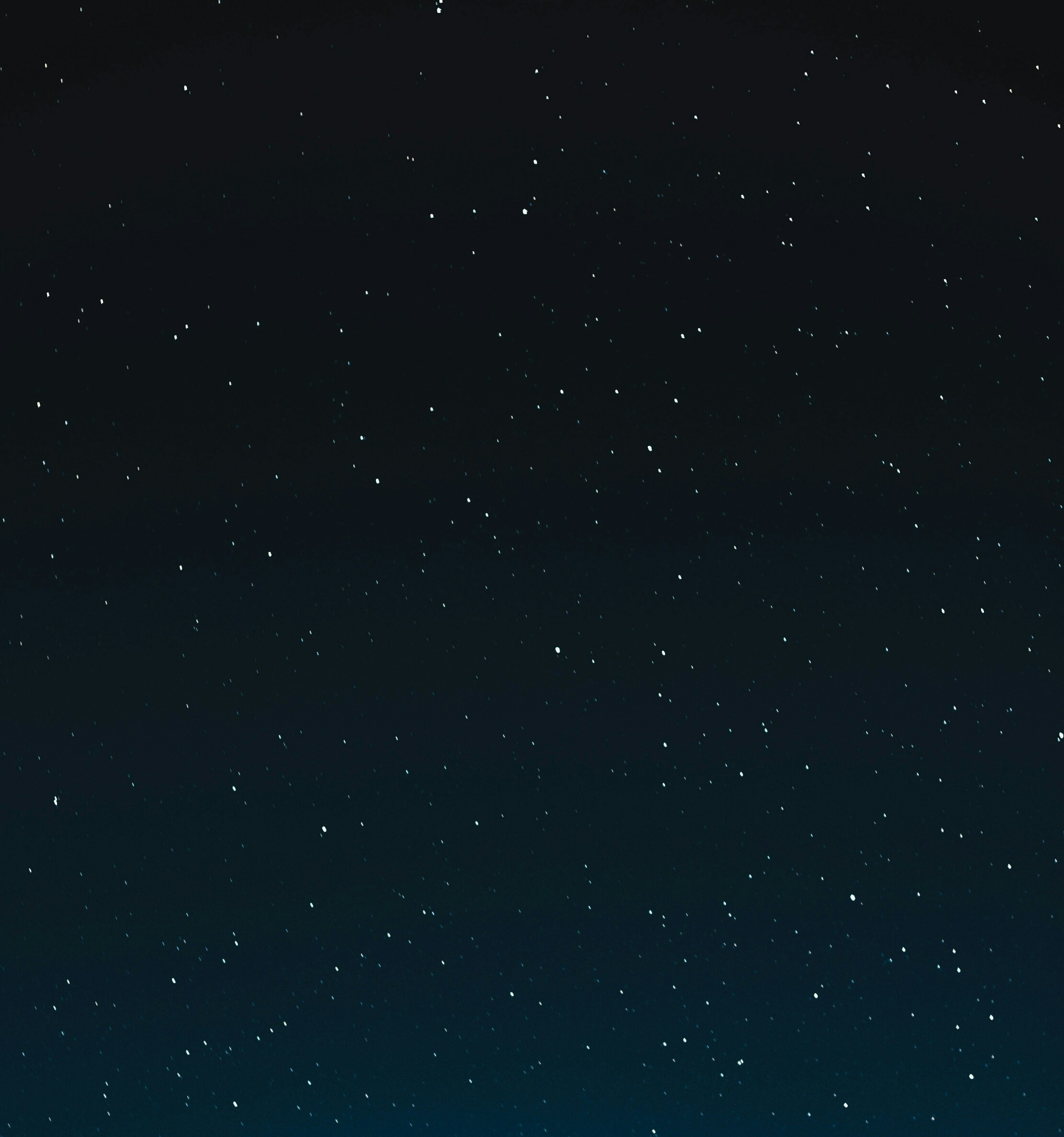 Starry night sky, dark blue with numerous white stars.
