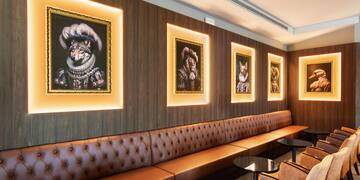 a room with a booth and a table and chairs