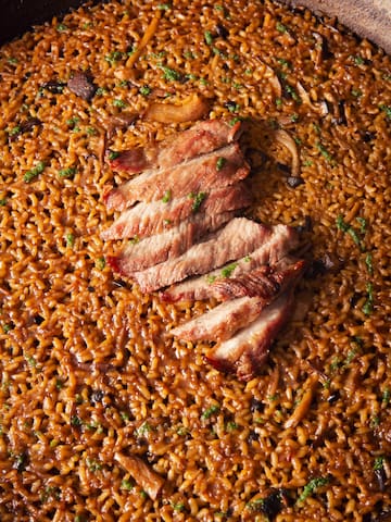 a plate of food with meat and rice