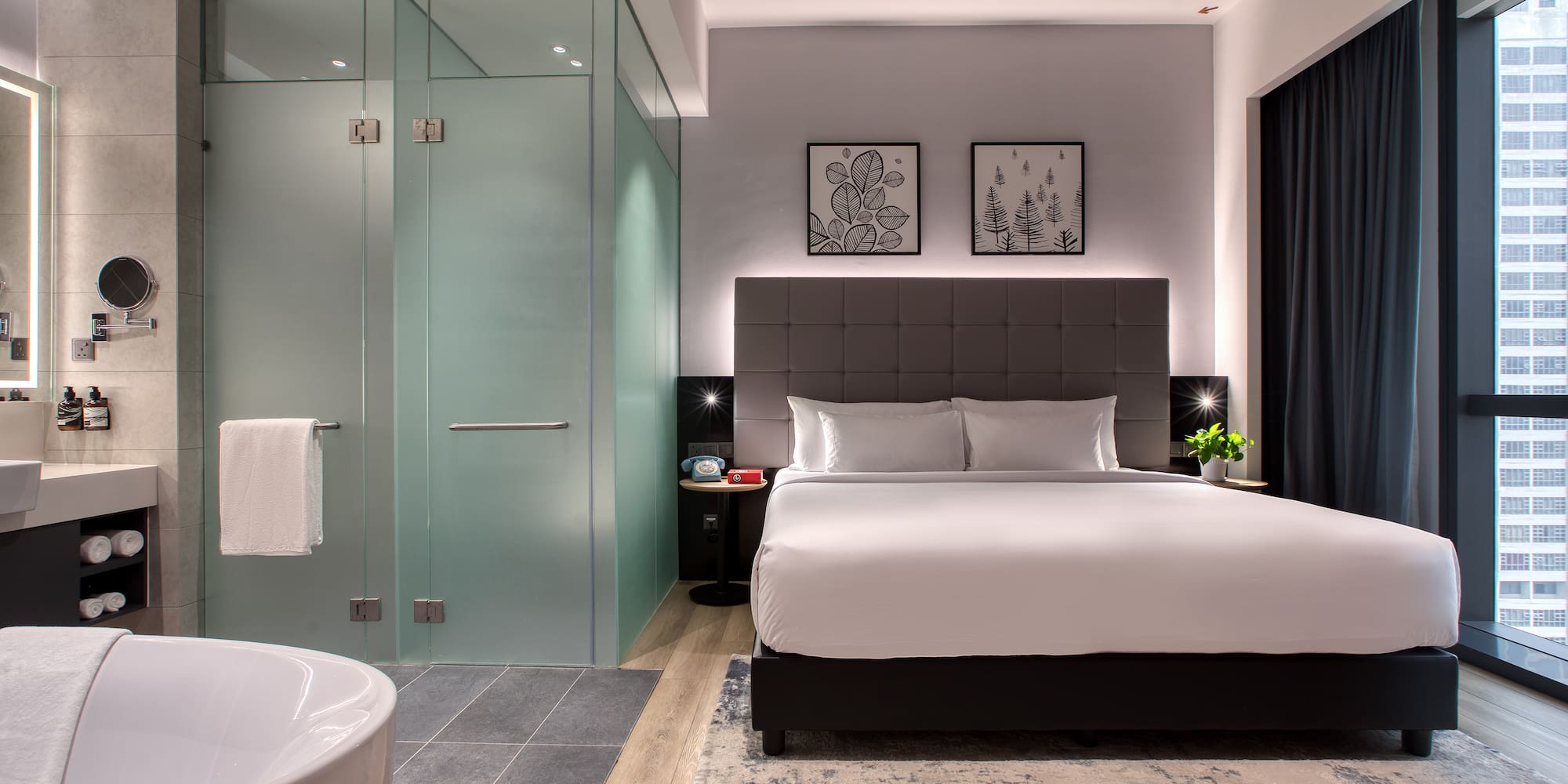 a bedroom with a glass shower and a bed