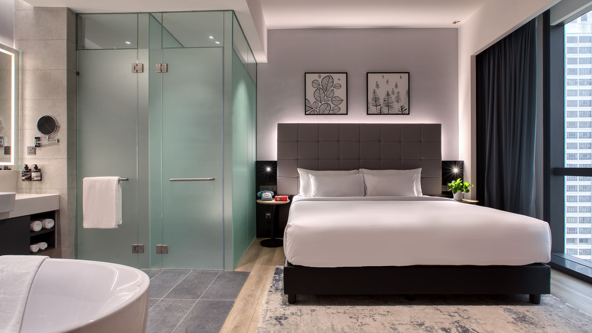 a bedroom with a glass shower and a bed
