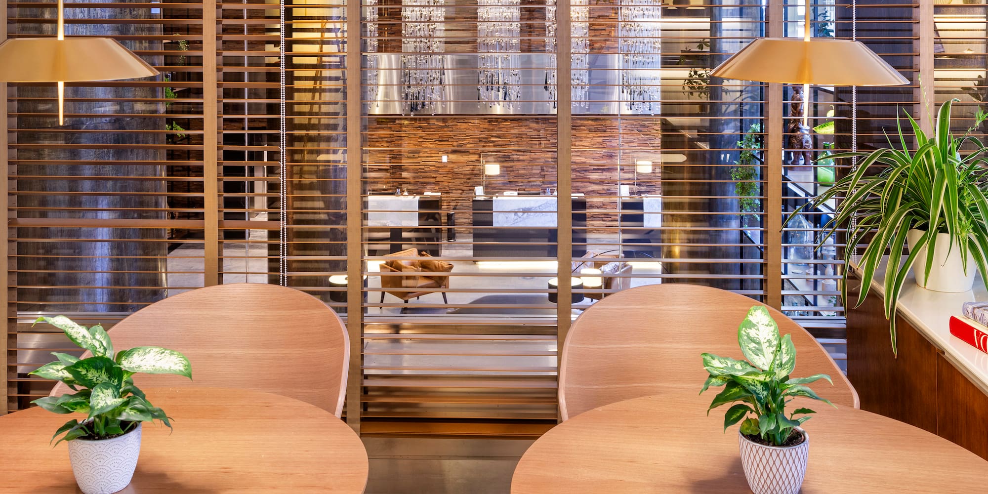 a room with a window and tables and plants