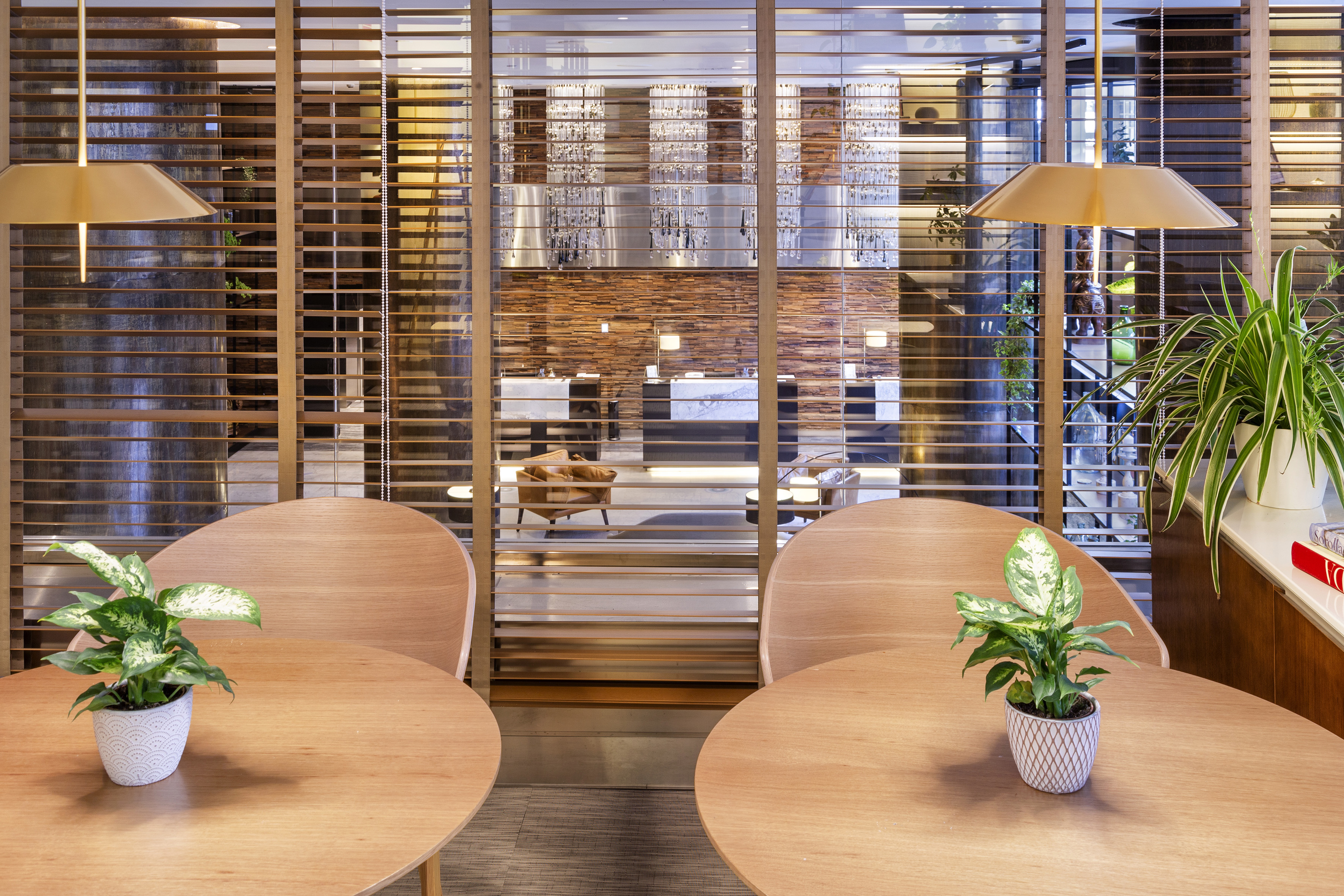 a room with a window and tables and plants