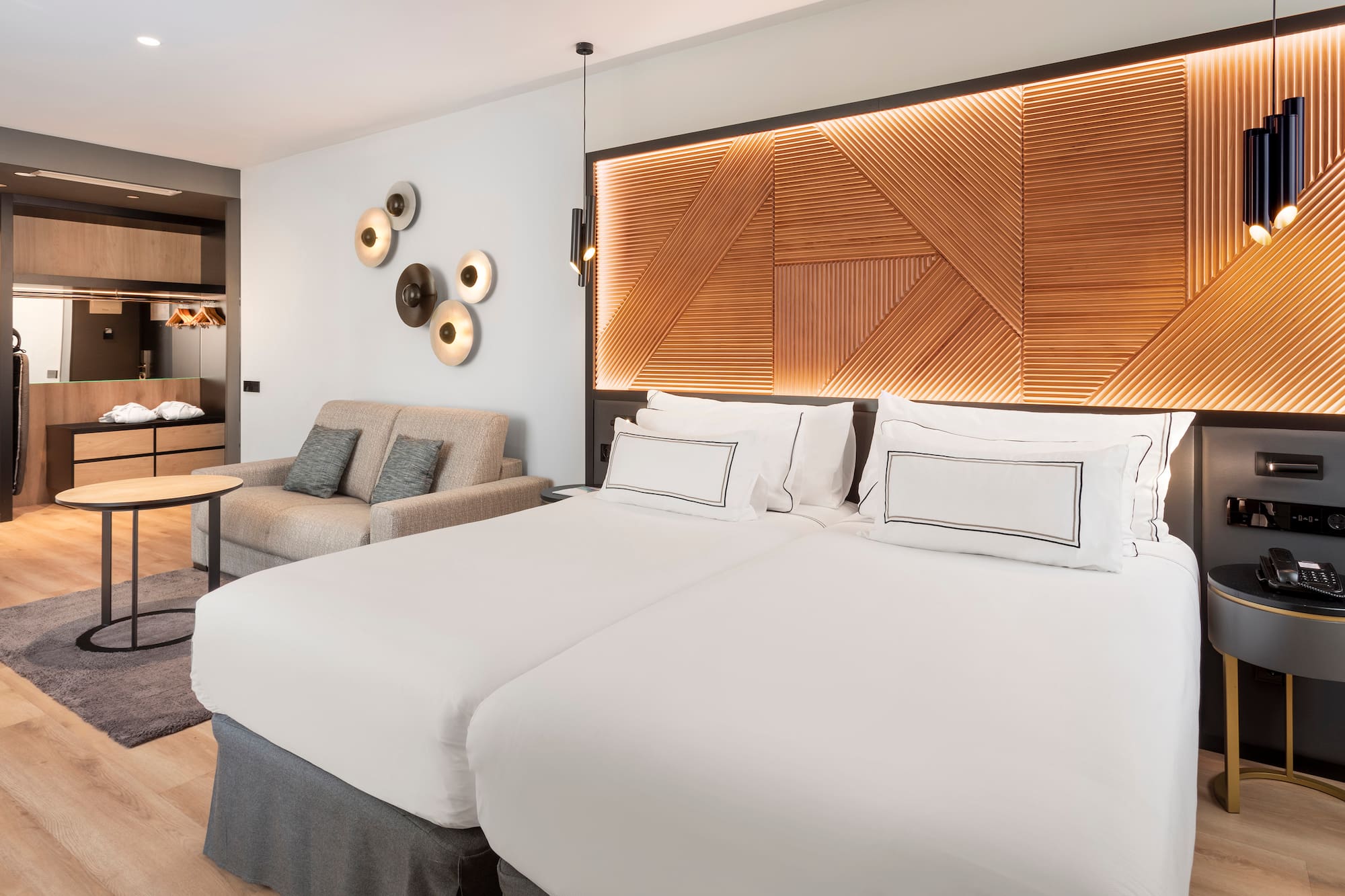 a room with two beds and a couch