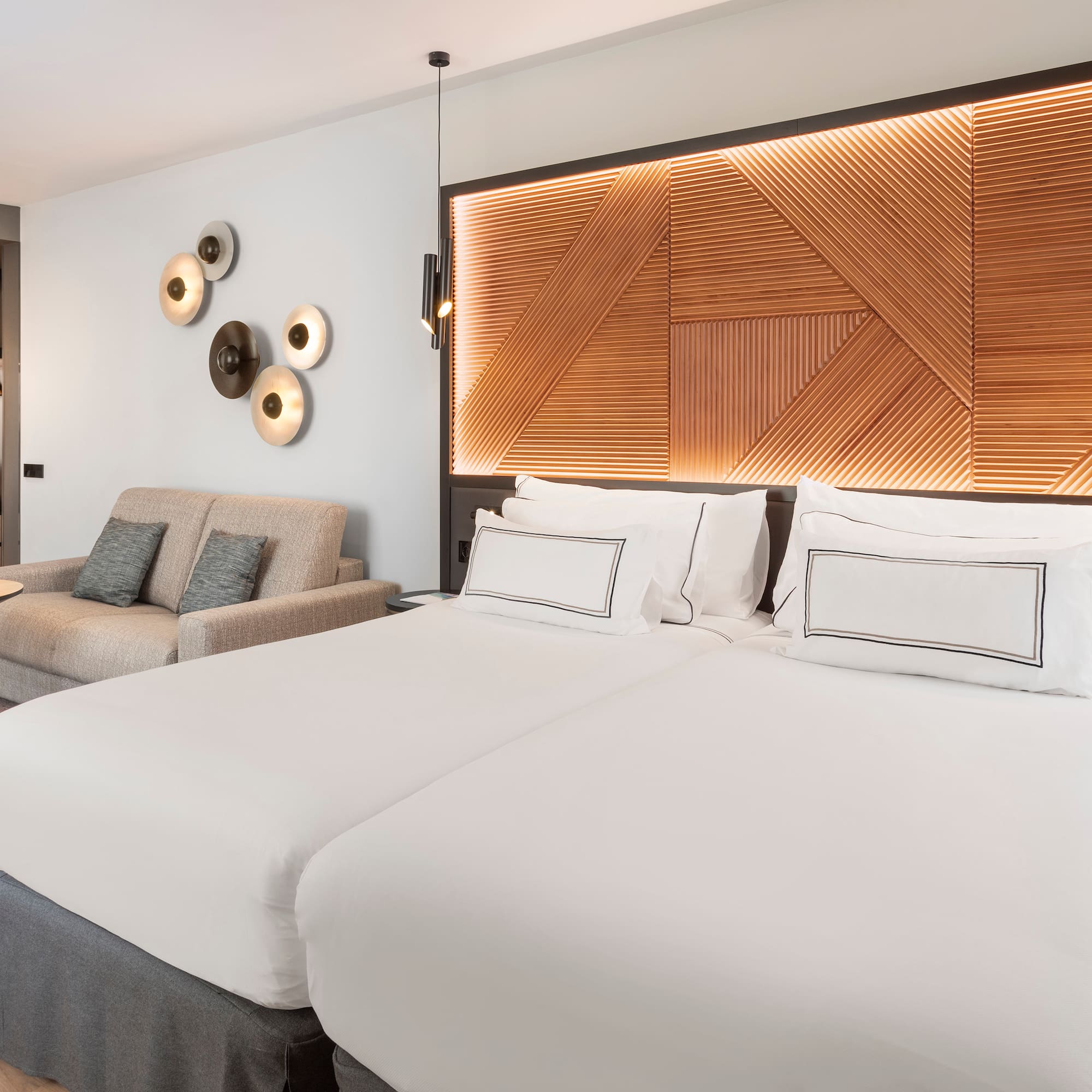 a room with two beds and a couch