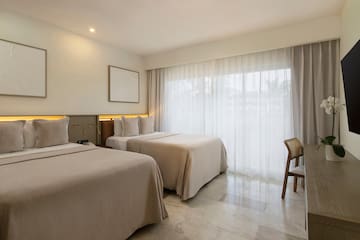 a room with two beds and a chair