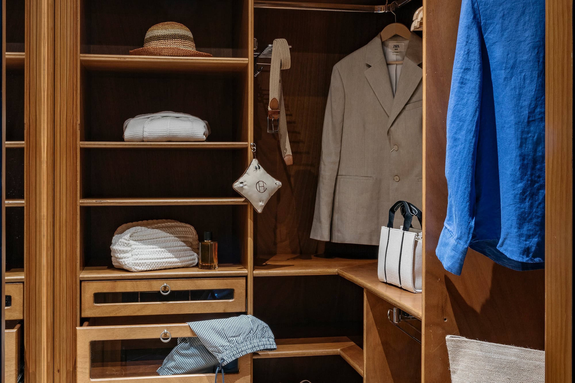 a closet with clothes and shoes