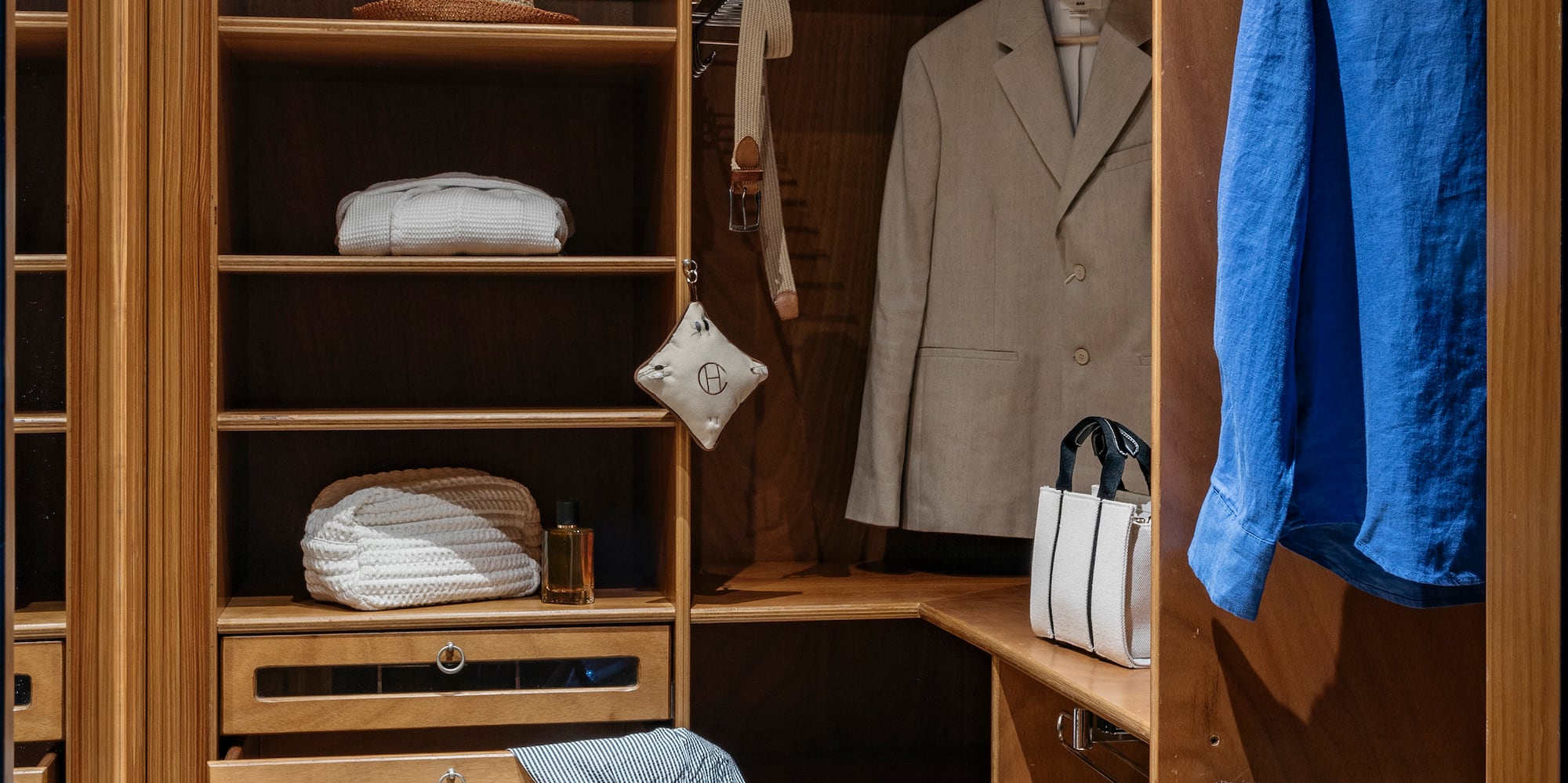 a closet with clothes and shoes