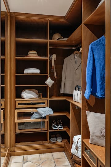 a closet with clothes and shoes