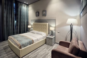 a bedroom with a bed and a chair