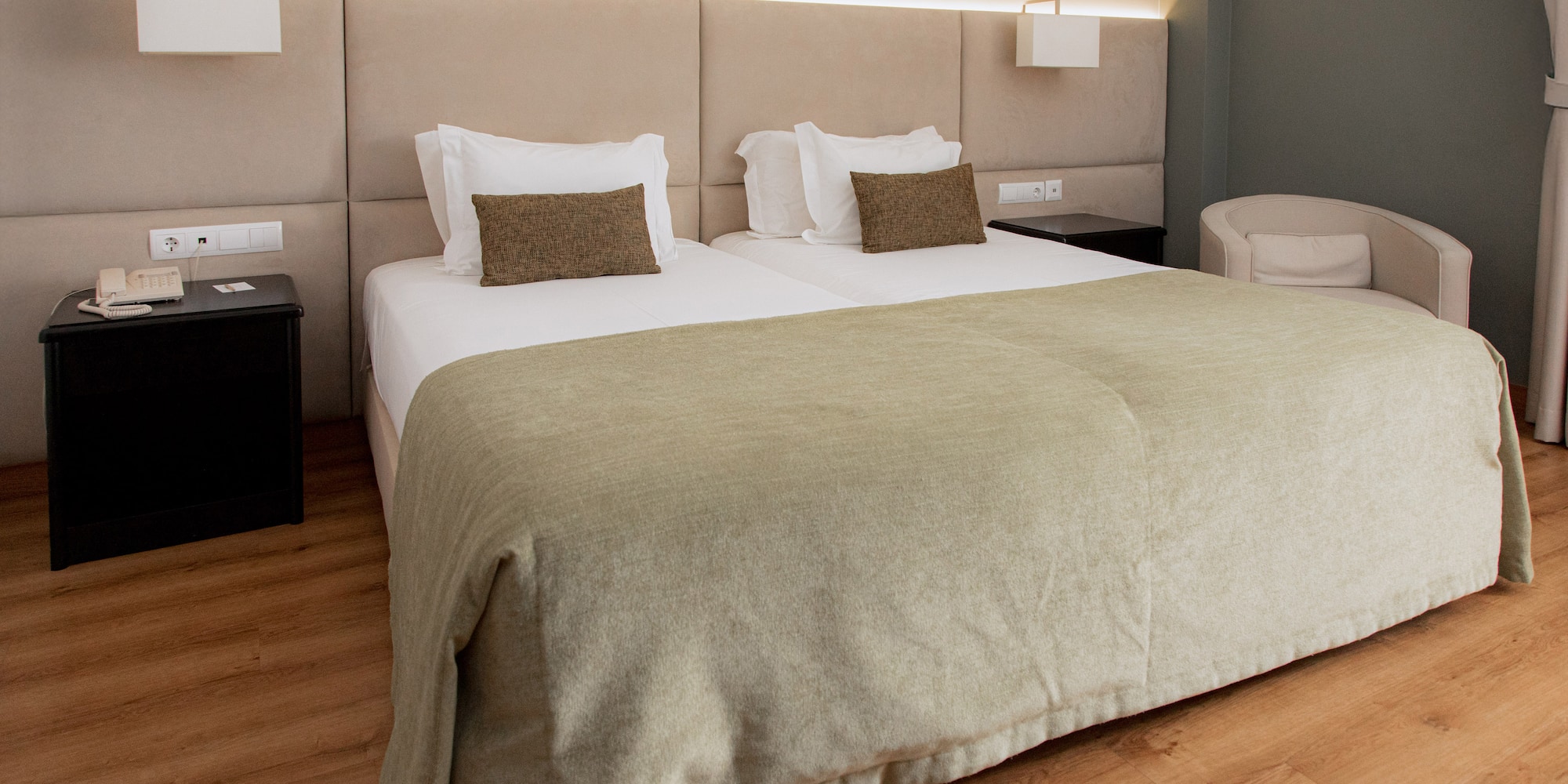 a bed with a headboard and a lamp