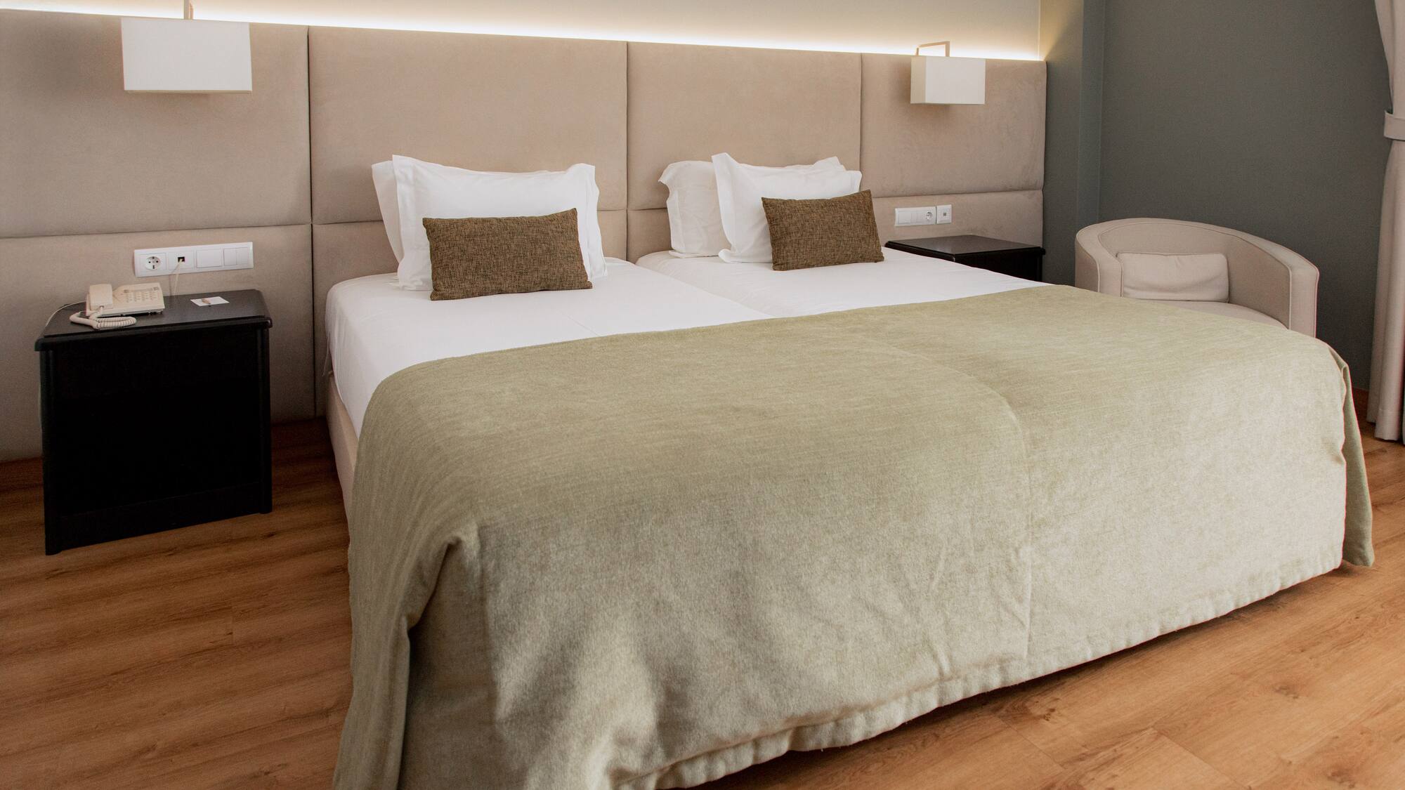 a bed with a headboard and a lamp