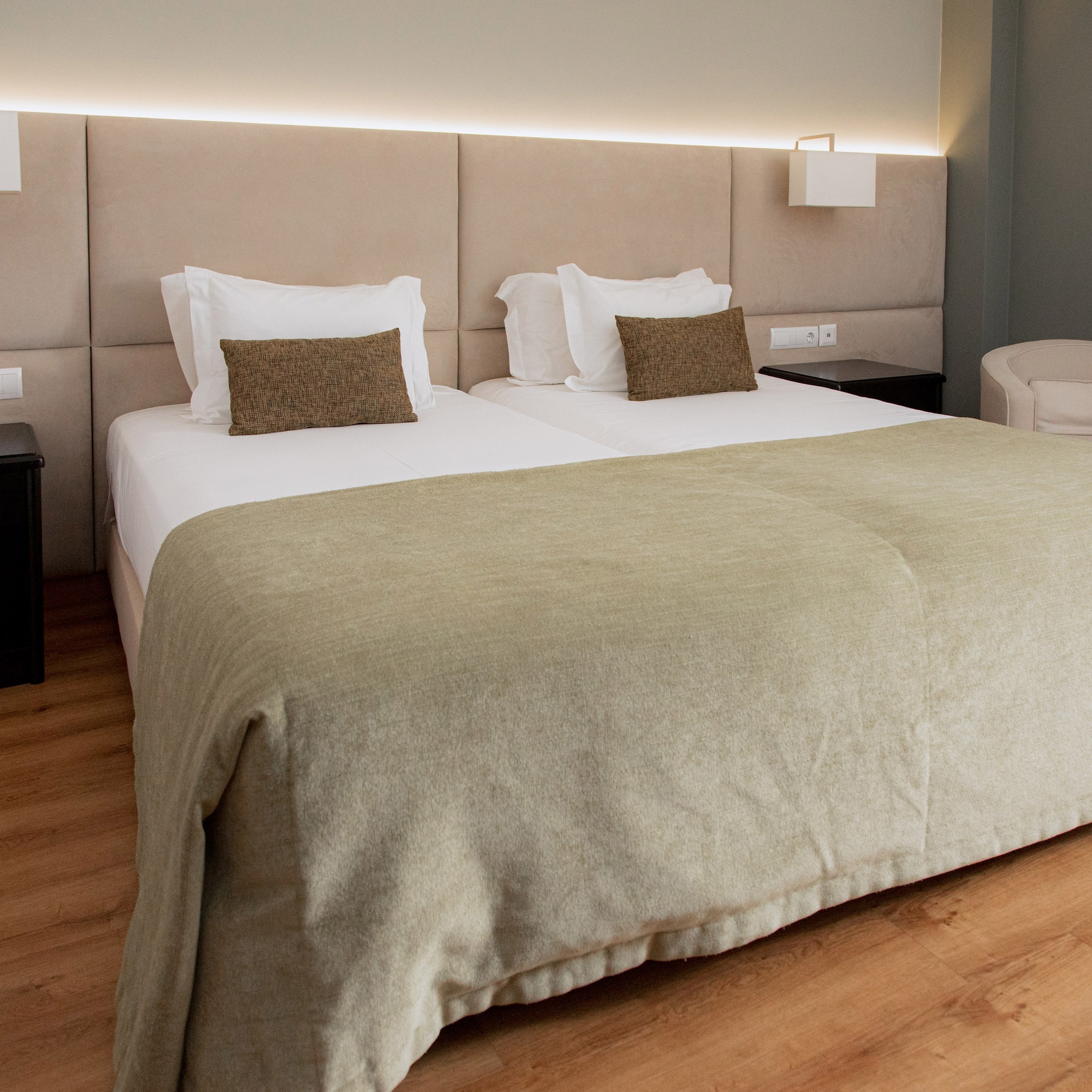 a bed with a headboard and a lamp