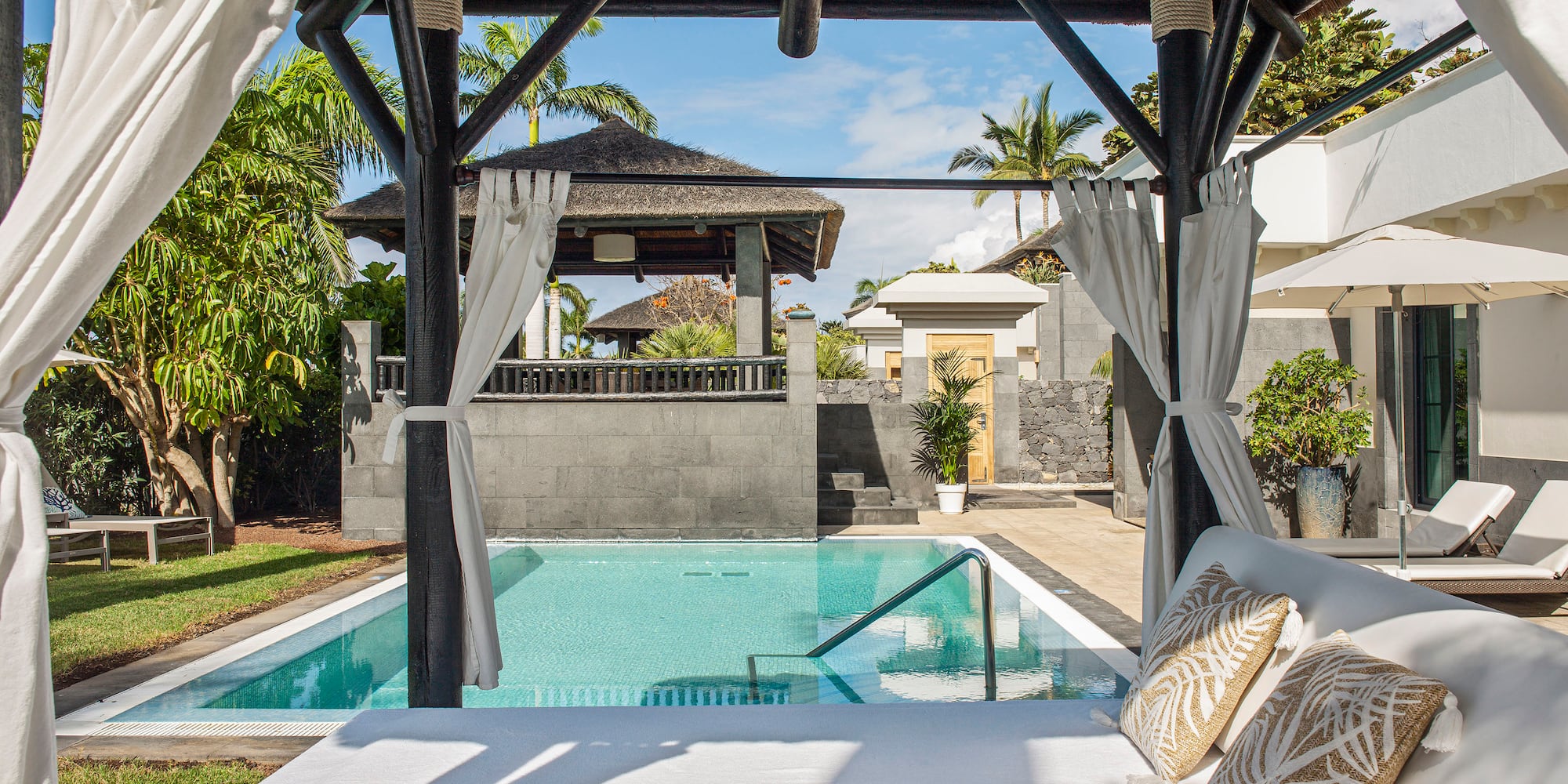 a pool with a bed and pillows