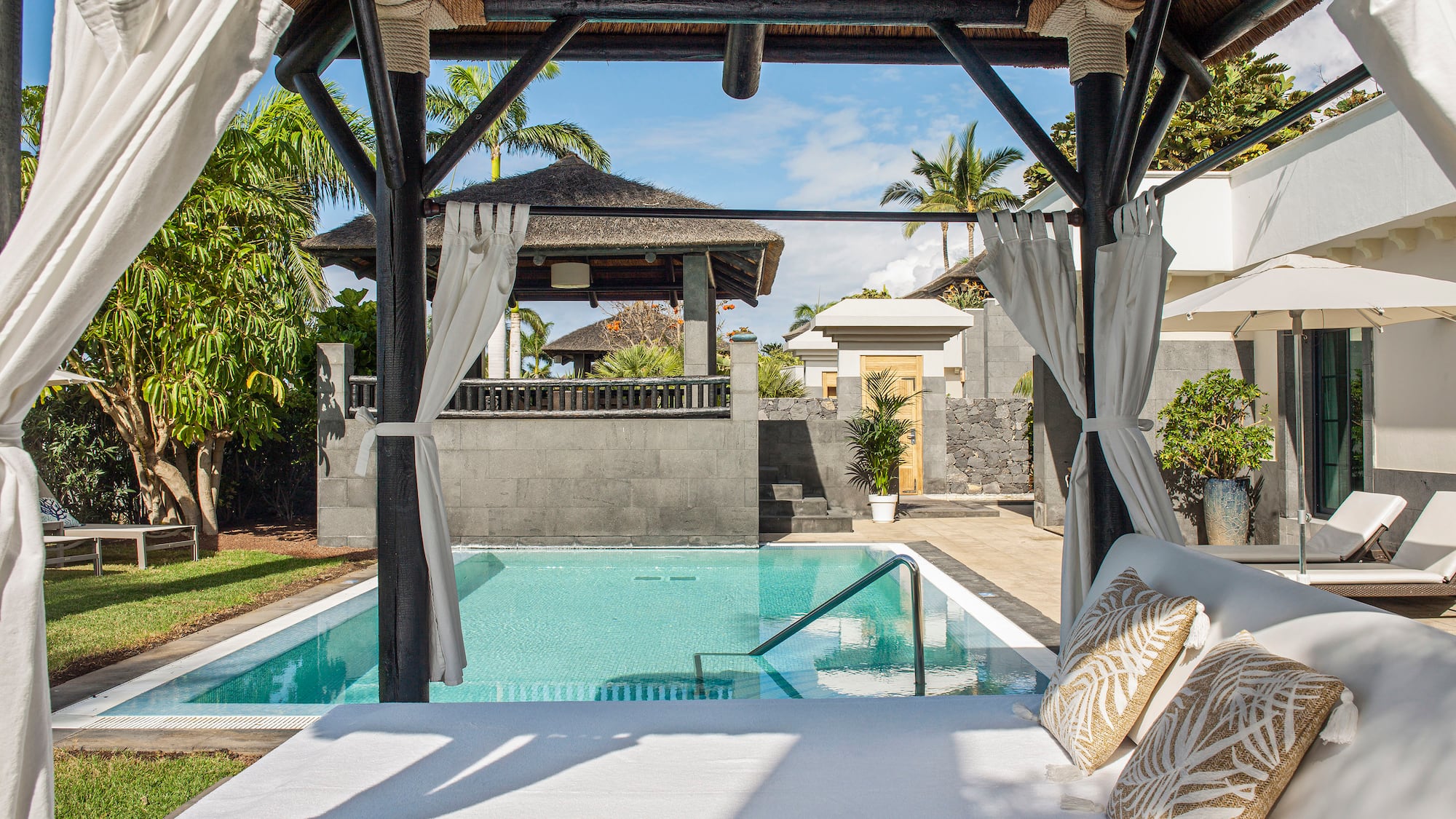 a pool with a bed and pillows