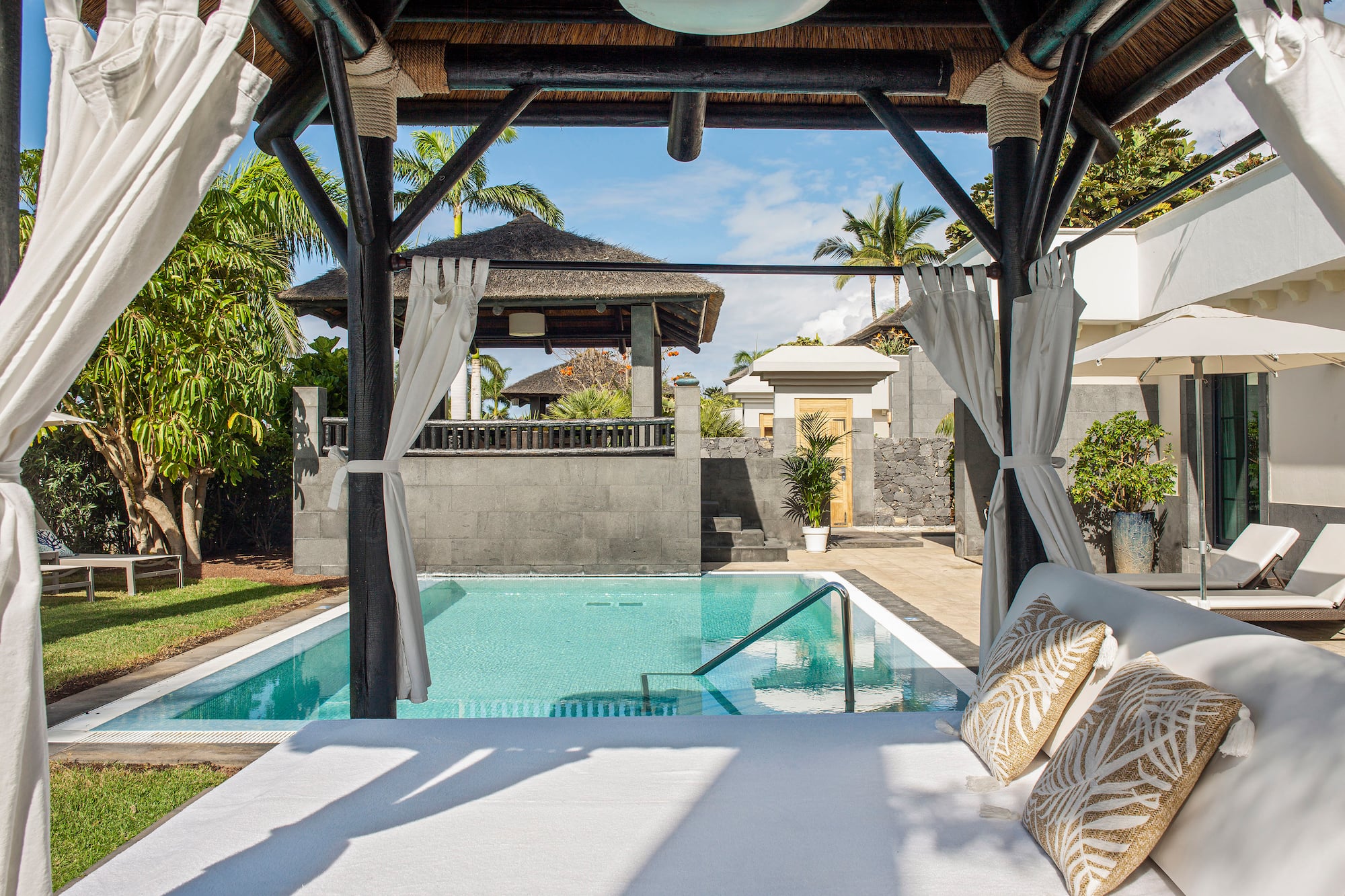 a pool with a bed and pillows