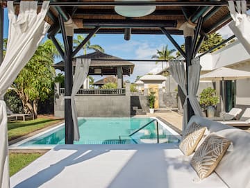 a pool with a bed and pillows