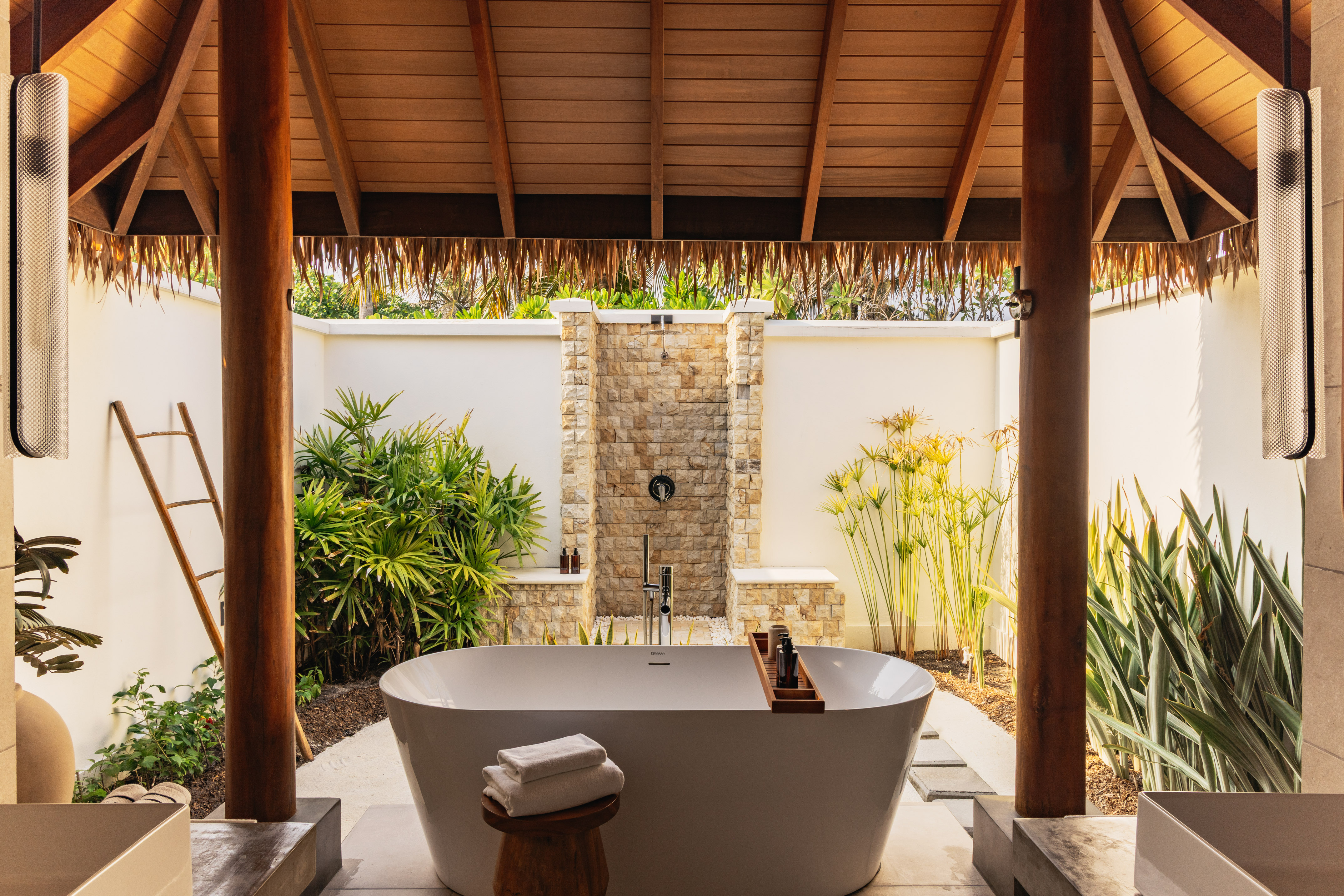 a bathtub outside with a shower