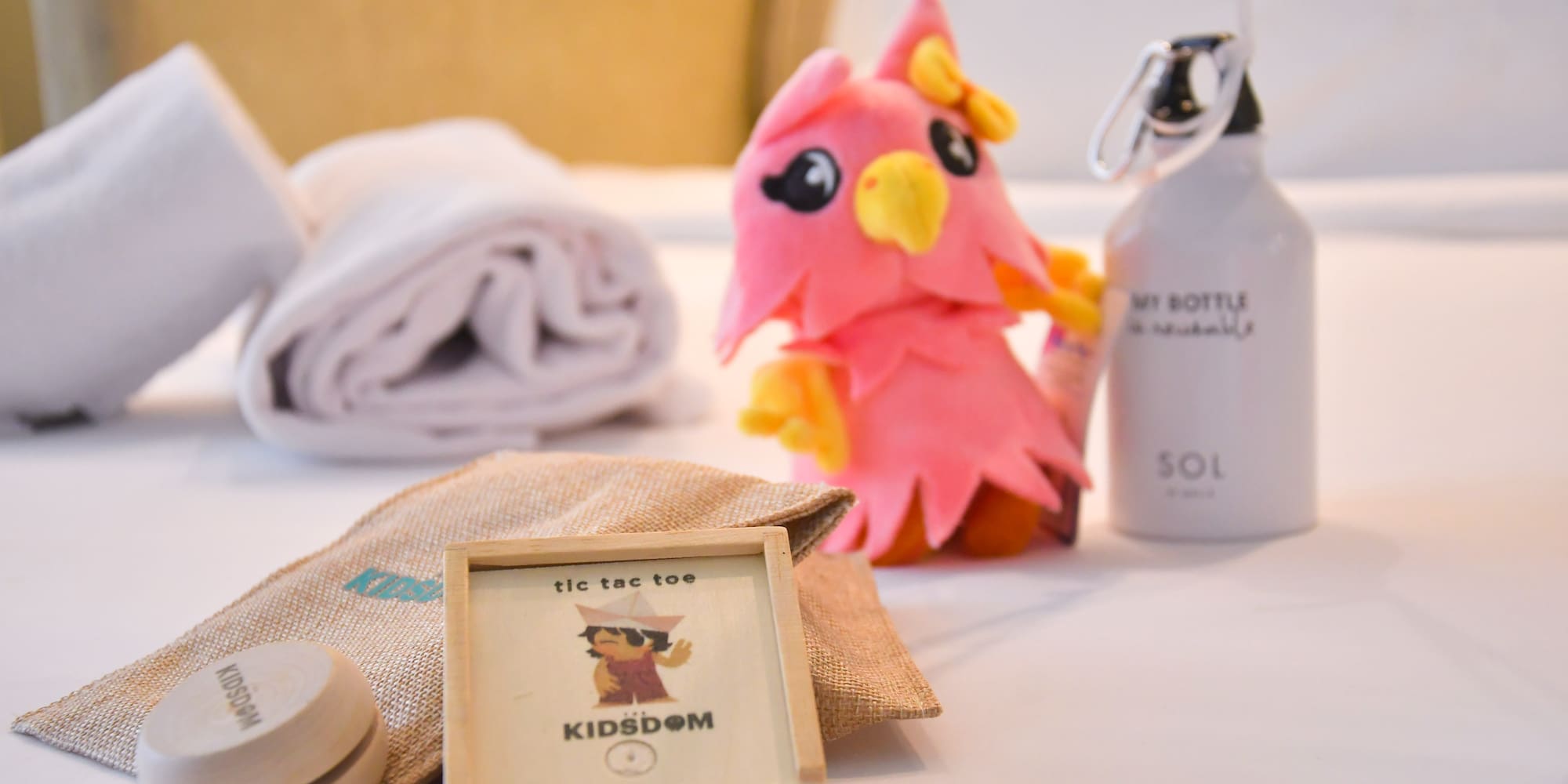 a stuffed animal next to a towel and a bottle