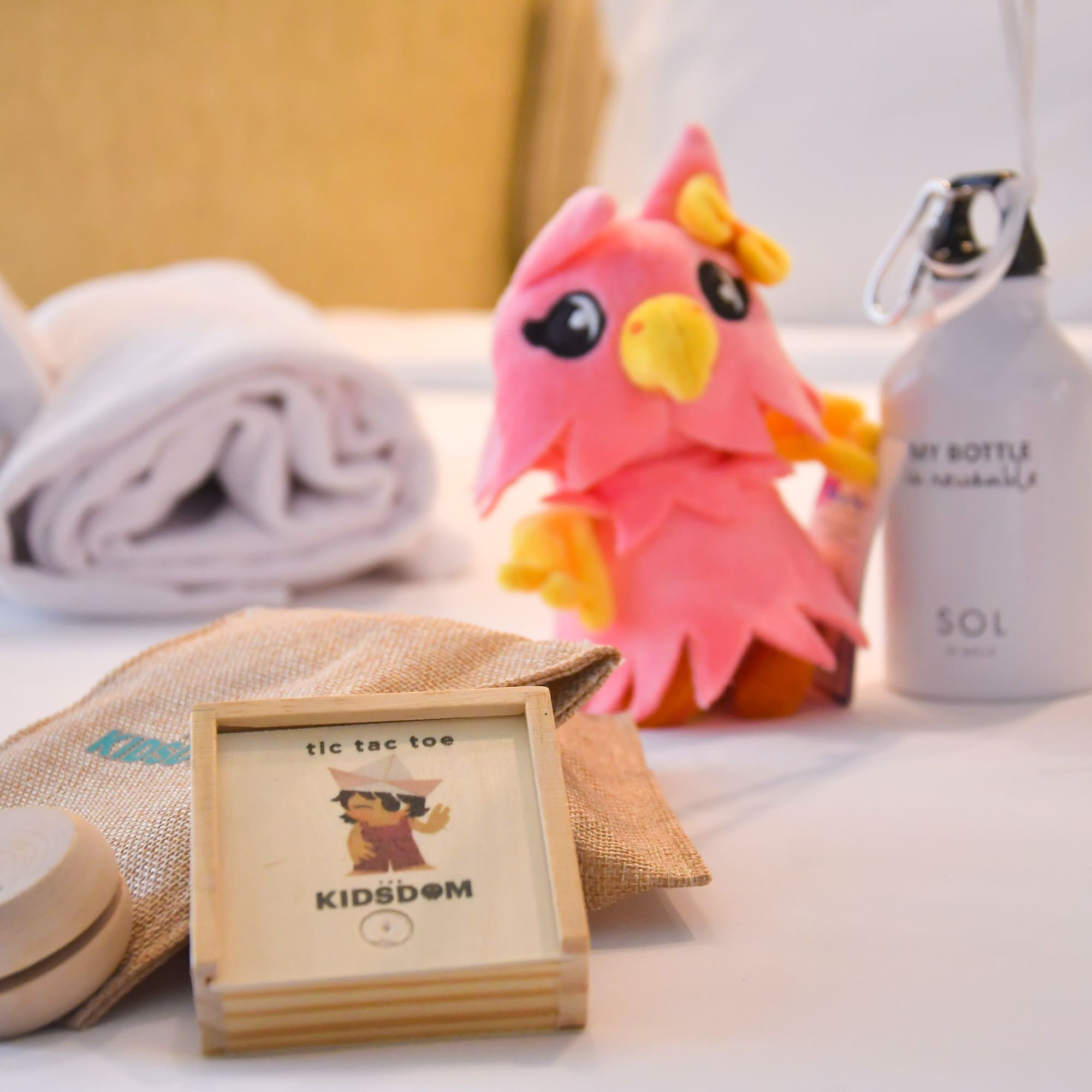 a stuffed animal next to a towel and a bottle