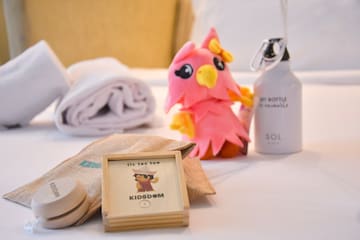 a stuffed animal next to a towel and a bottle