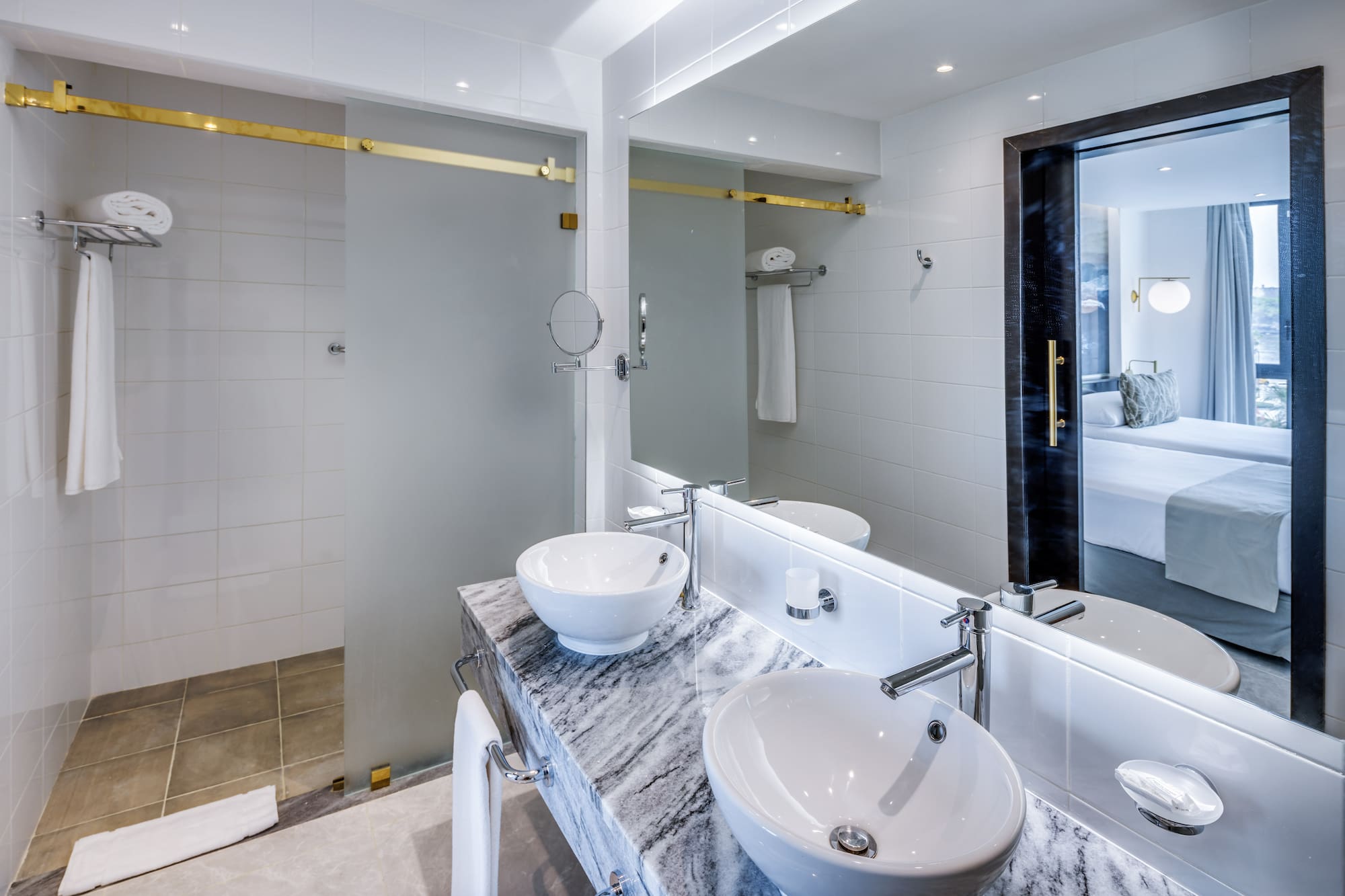 a bathroom with a marble countertop sink and a shower