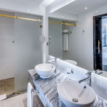 a bathroom with a marble countertop sink and a shower