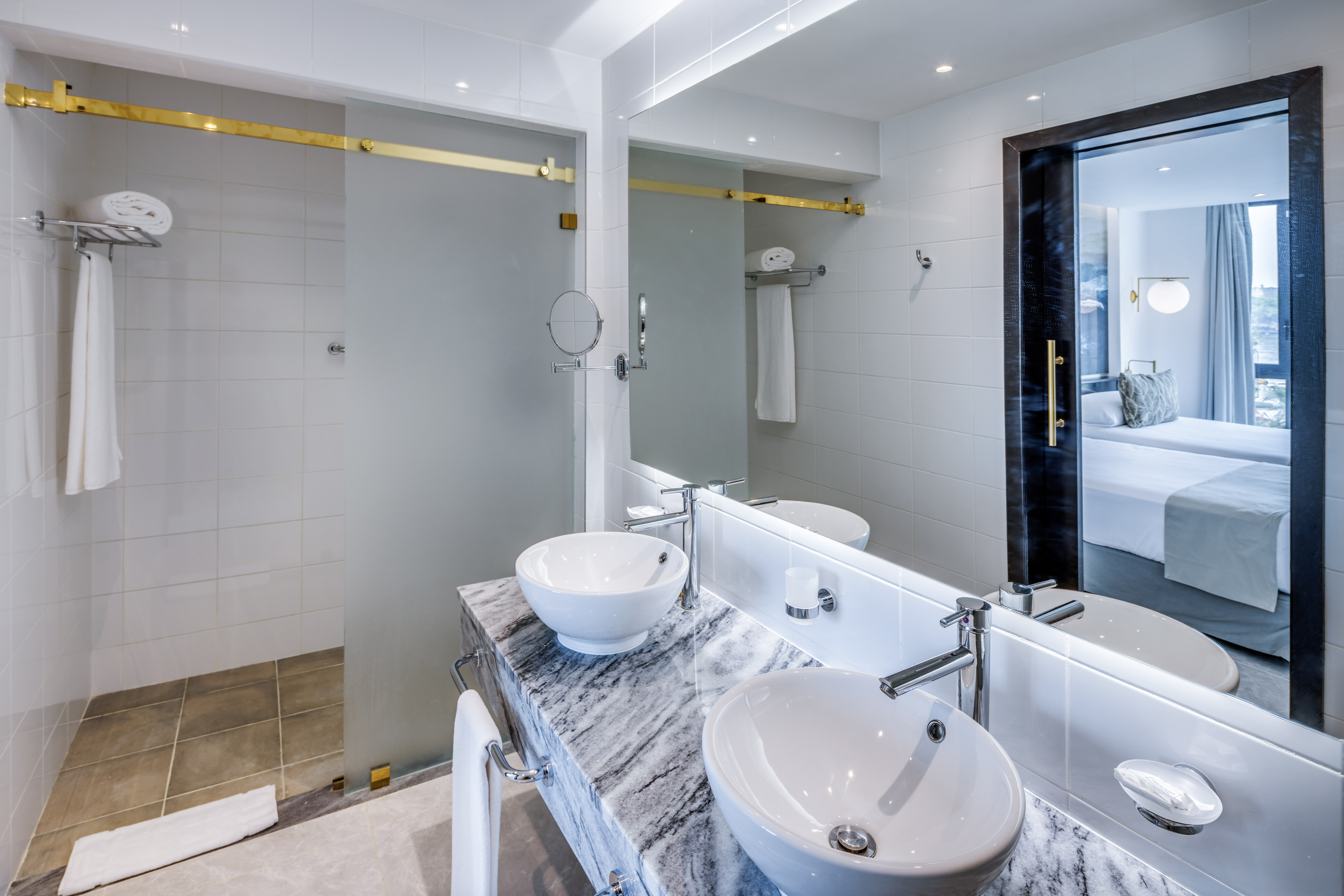 a bathroom with a marble countertop sink and a shower