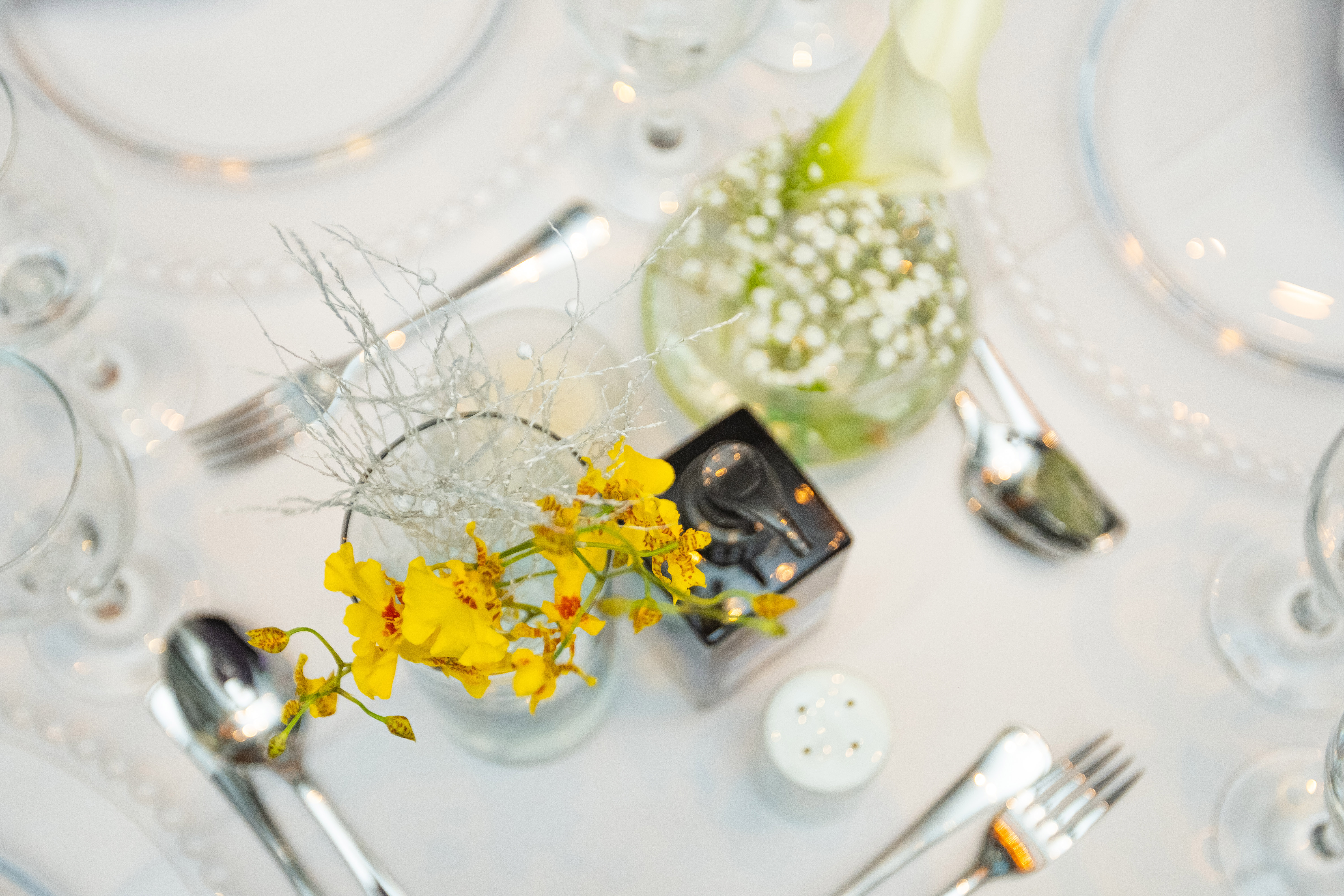a table set with silverware and flowers